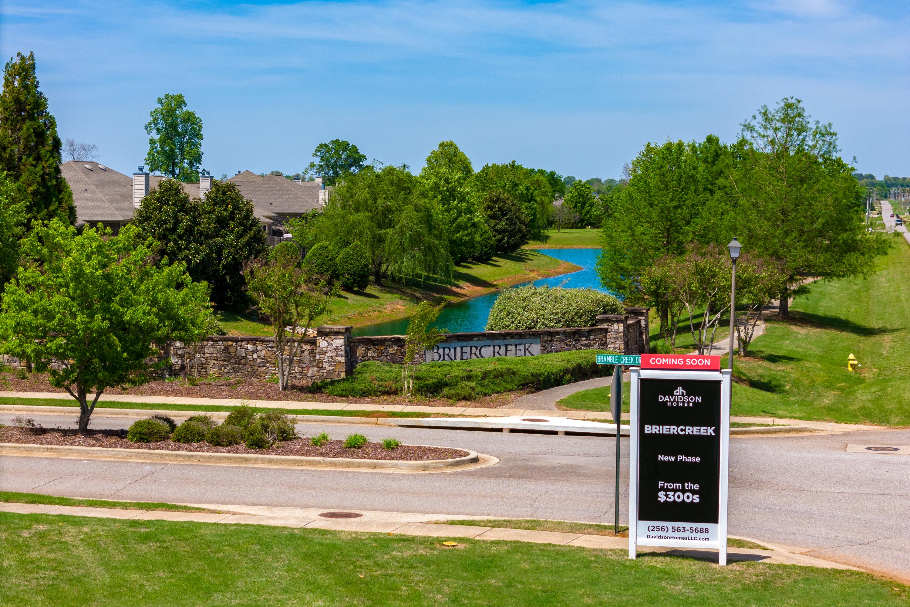 Brier Creek community entrance in Meridianville Alabama featuring scenic creek, lush trees, and Davidson Homes new phase sign from $380k