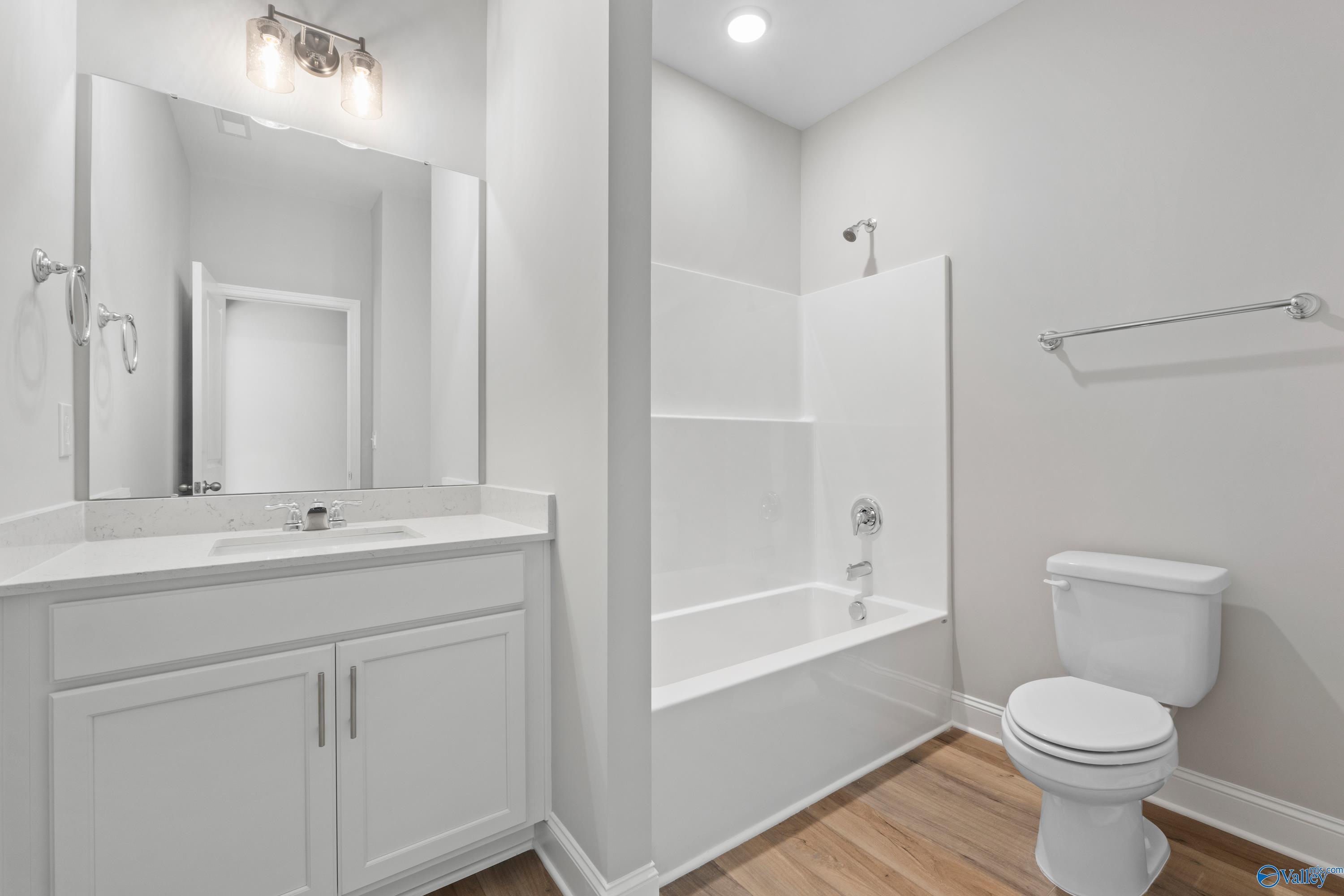 Bright modern bathroom featuring white double vanity, soaking tub, walk-in shower in Davidson Homes Everett B, Toney, AL