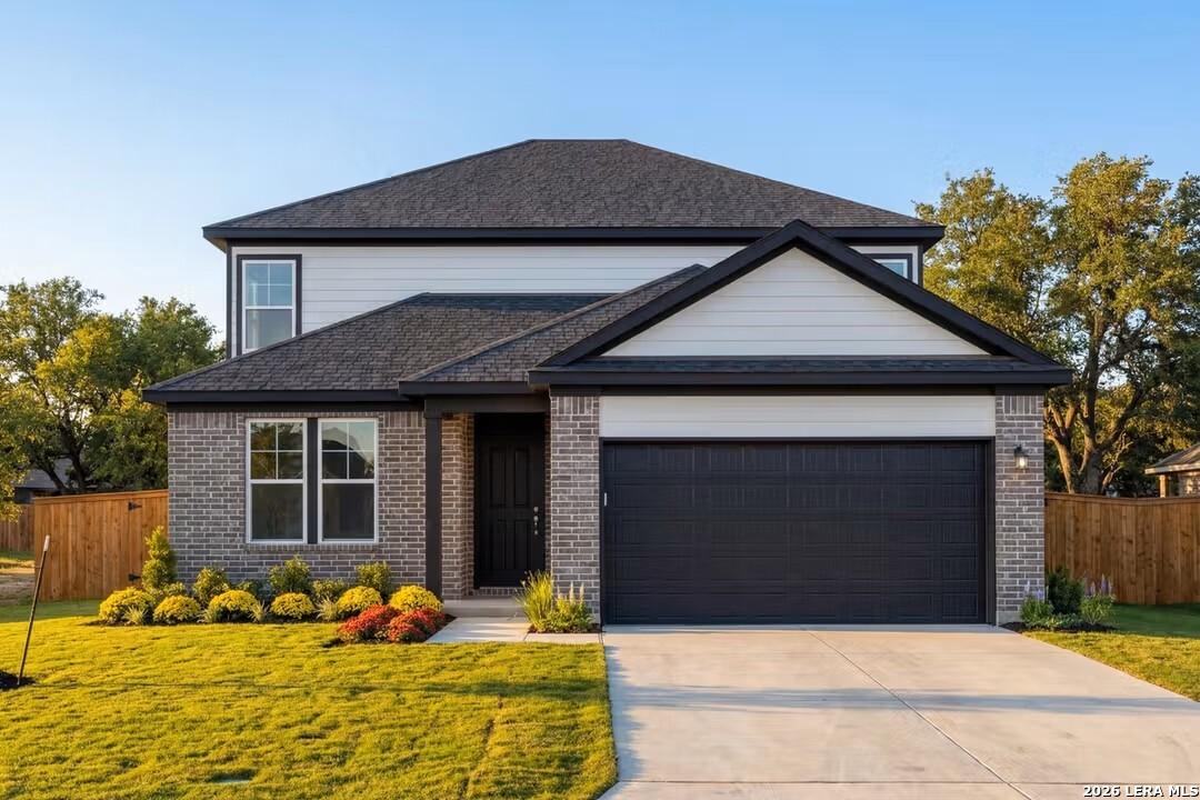 Modern 2-story Douglas C home with brick accents, black roof, 2-car garage, and landscaped yard in Horizon Pointe, Converse, Texas