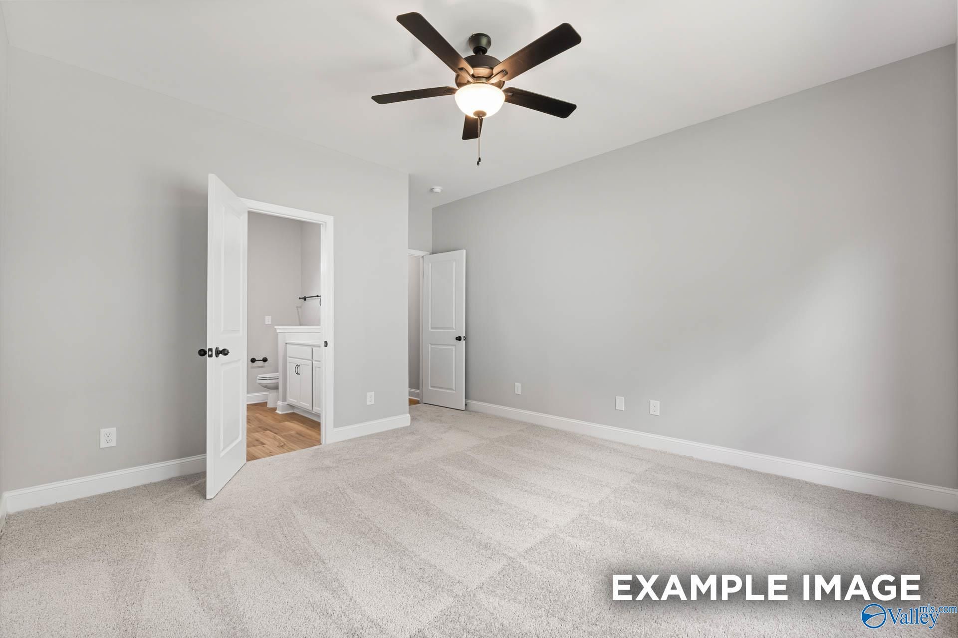 Spacious master bedroom with ceiling fan, gray walls, and open en-suite bath in The Asheville C by Davidson Homes, Hazel Green, AL