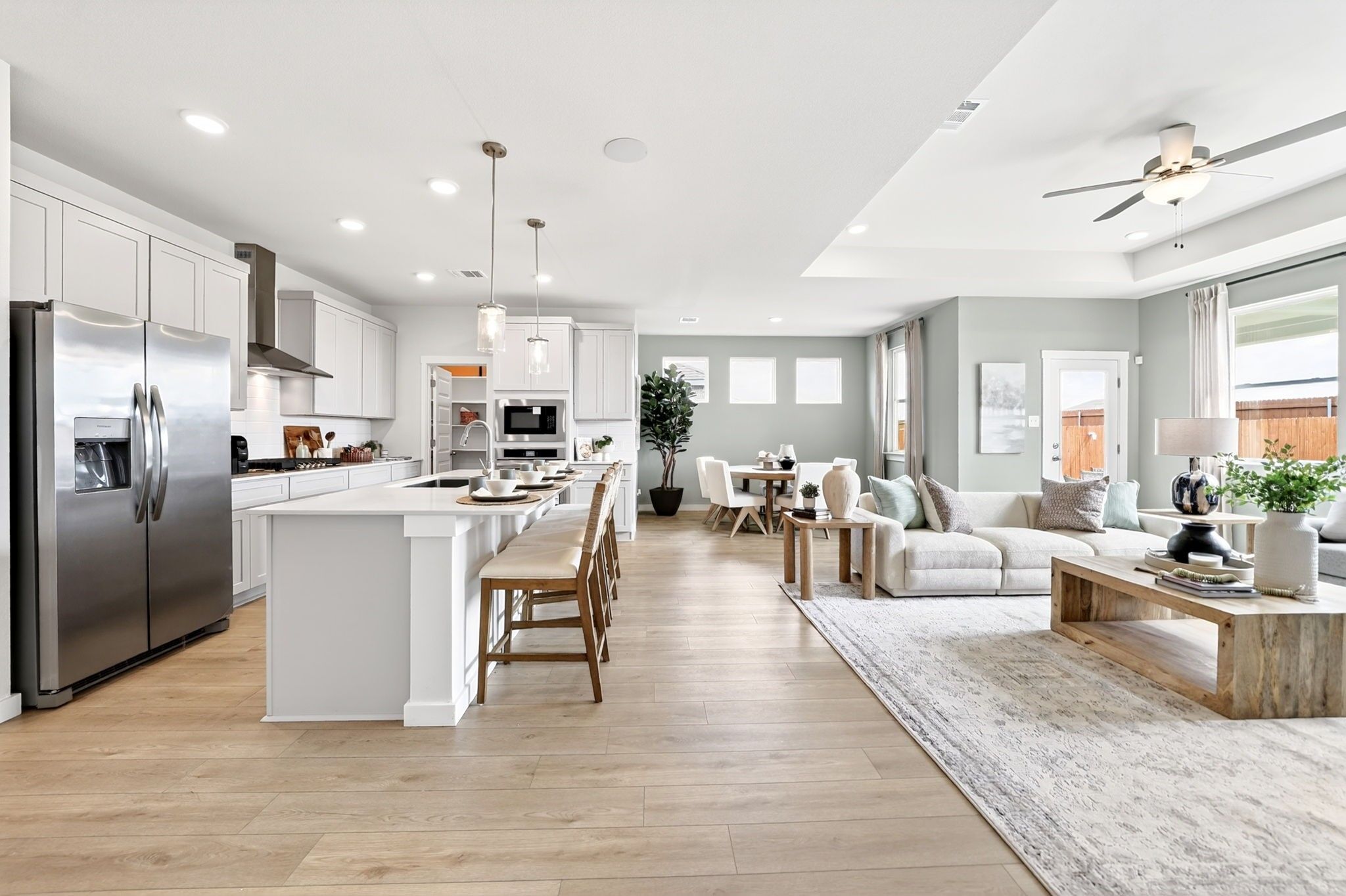 Open-concept kitchen and living area in The Laurel M floor plan at Parks at Foster Crossing in Anna, Texas.