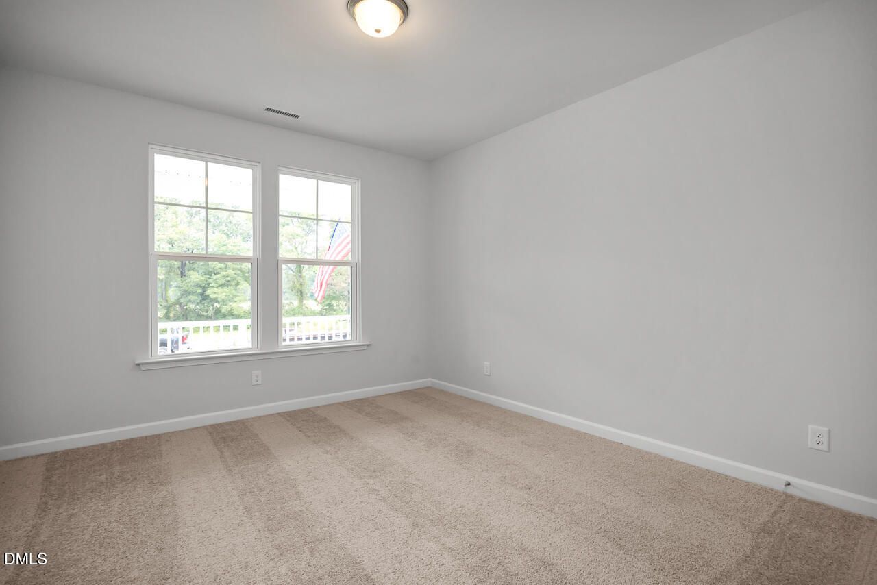 Bright secondary bedroom with large windows, gray walls, and beige carpet in Davidson Homes The Hickory II B, Lillington, NC