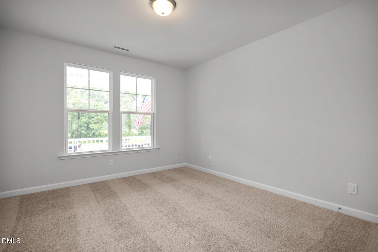 Bright secondary bedroom with large windows, gray walls, and beige carpet in Davidson Homes The Hickory II B, Lillington, NC