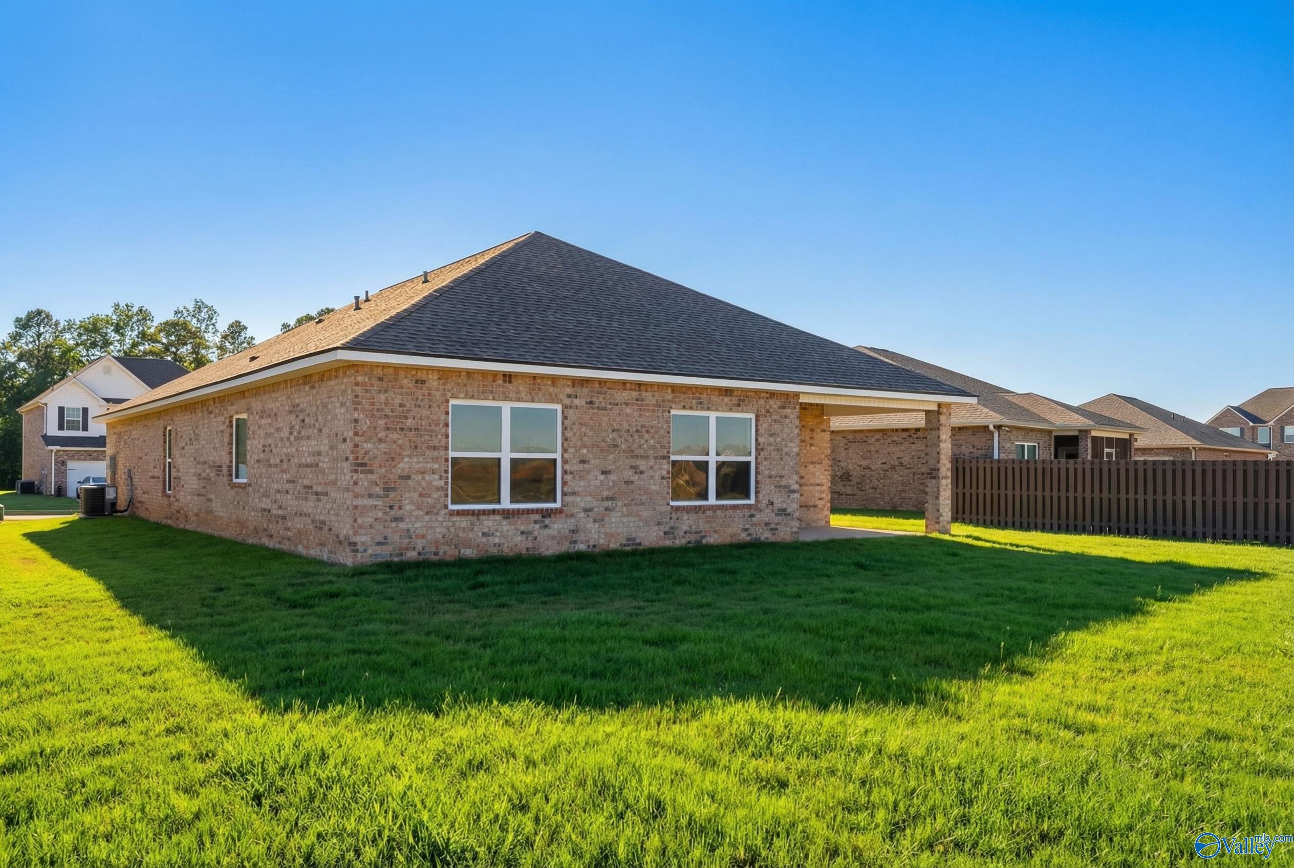 Single-story brick 4-bedroom home with 2-car garage and fenced yard in Creekside, Harvest, Alabama by Davidson Homes Everett plan