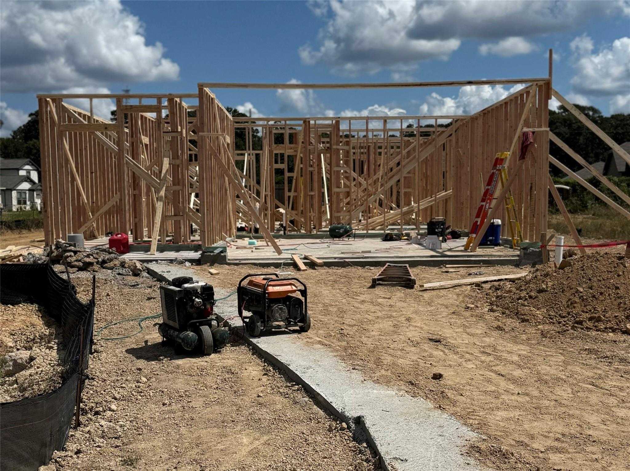 Wooden framing stage of 3-bedroom The Frio F home under construction in Liberty Estates, Cleveland, Texas by Davidson Homes