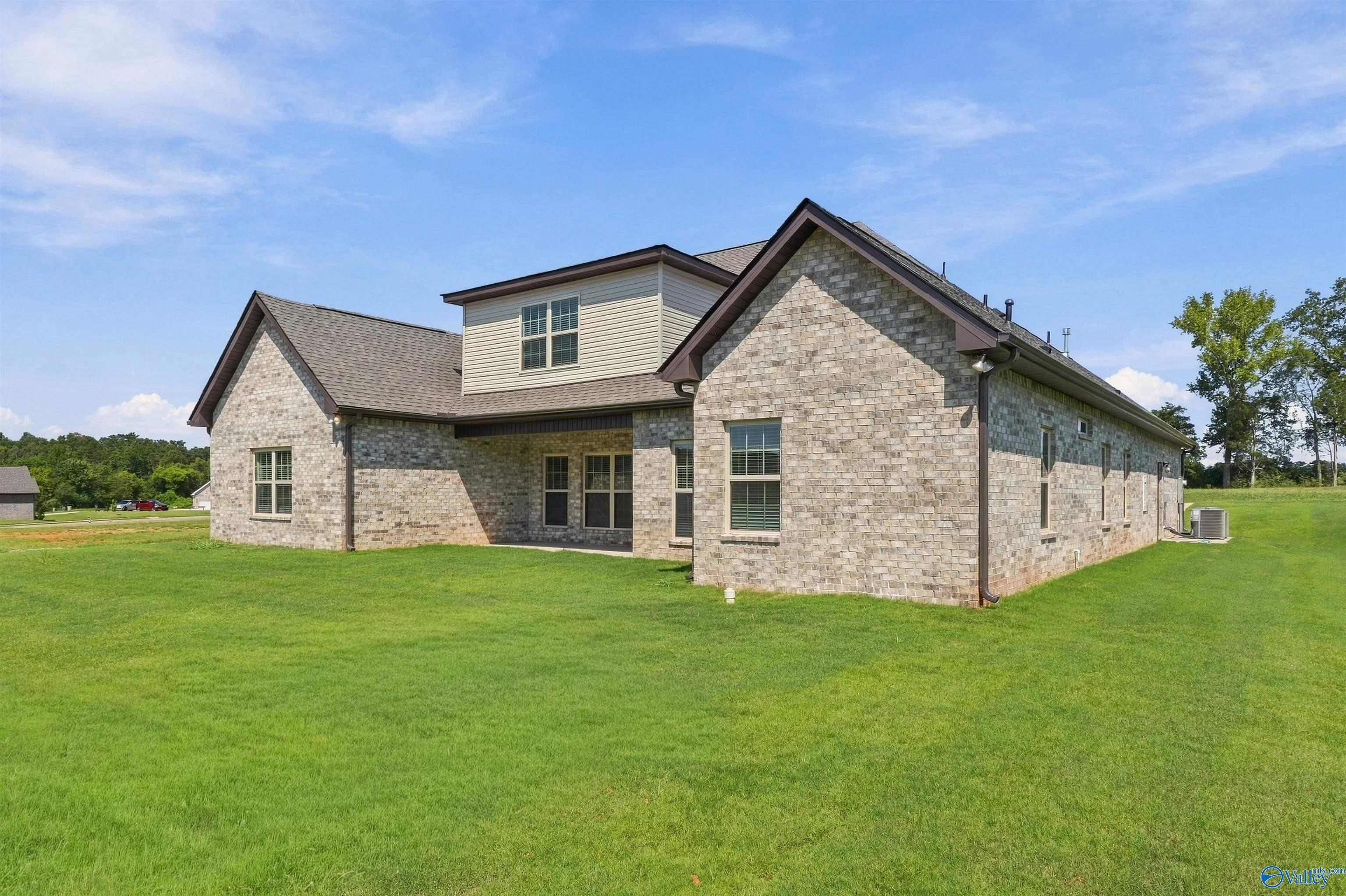 Brick exterior of Davidson Homes' The Valencia with Bonus in Riverton Preserve, Huntsville, Alabama, with large backyard