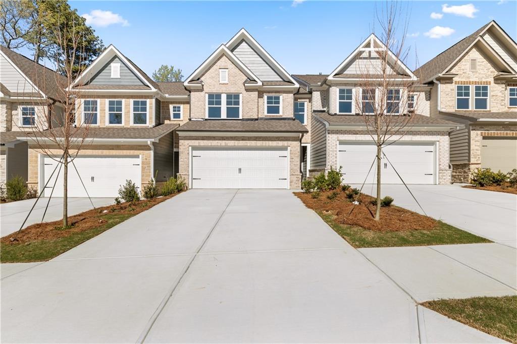 Row of modern two-story townhomes with two-car garages and driveways in Lake Shore, Winder, Georgia by Davidson Homes The Cary A