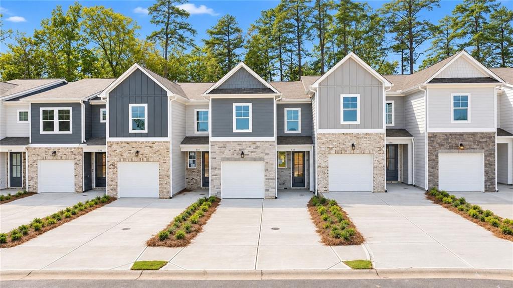 Modern two-story townhomes with attached garages and brick accents in Davidson Homes' Stegall Village community, Emerson, Georgia