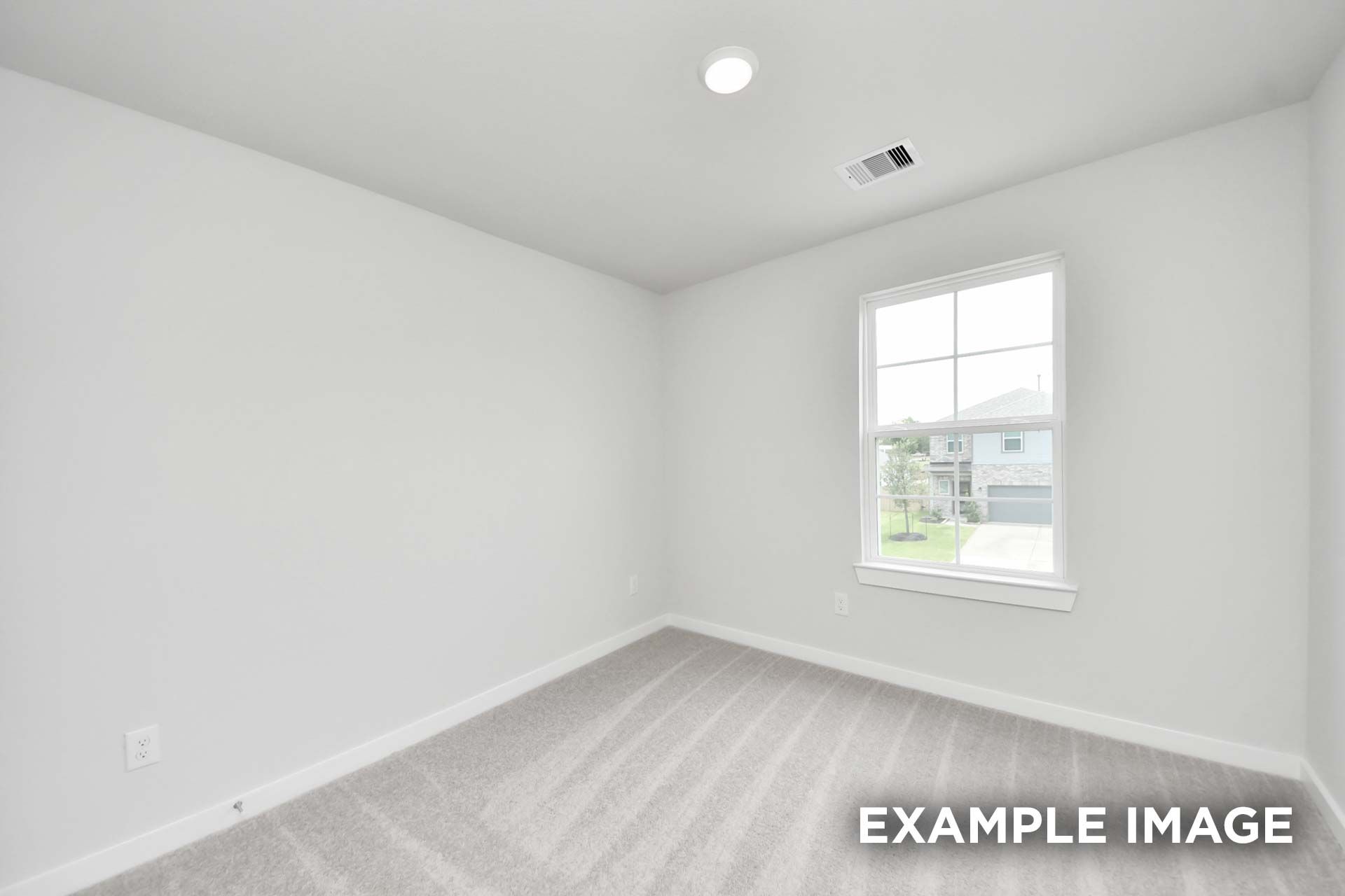 Bright empty bedroom in The Blanco by Davidson Homes with carpet, single-pane window, and recessed lighting, Beasley TX new home.