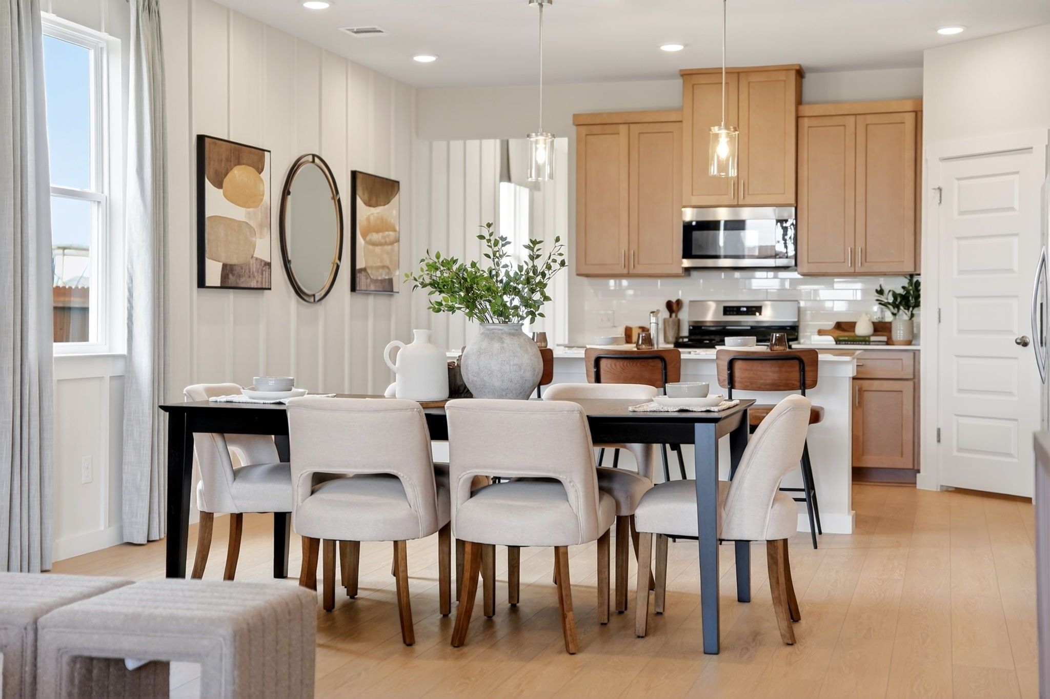 Modern dining room with open-concept kitchen in The Sabine J floor plan by Davidson Homes in Heartland, Texas.