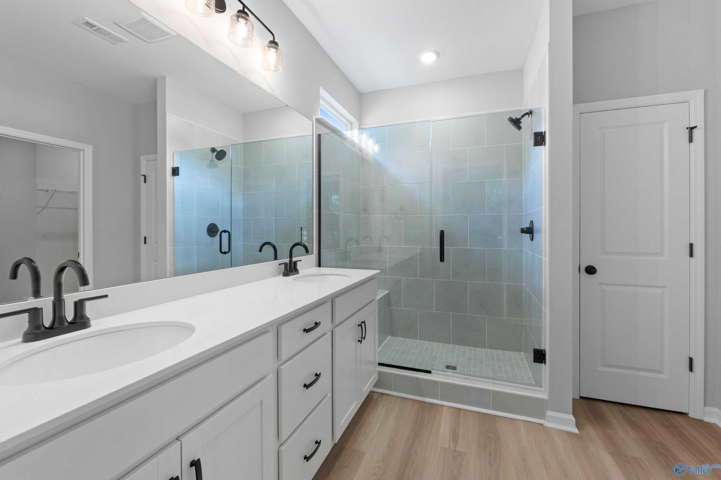 Modern master bathroom with double vanity, frameless glass shower, subway tile in Davidson Homes The Phoenix, Hazel Green AL