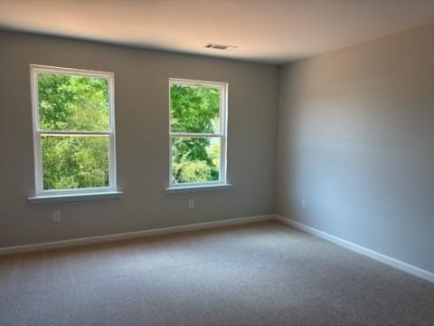 Bright empty bedroom with large windows and natural light in Davidson Homes The Rabun A, Winder, Georgia