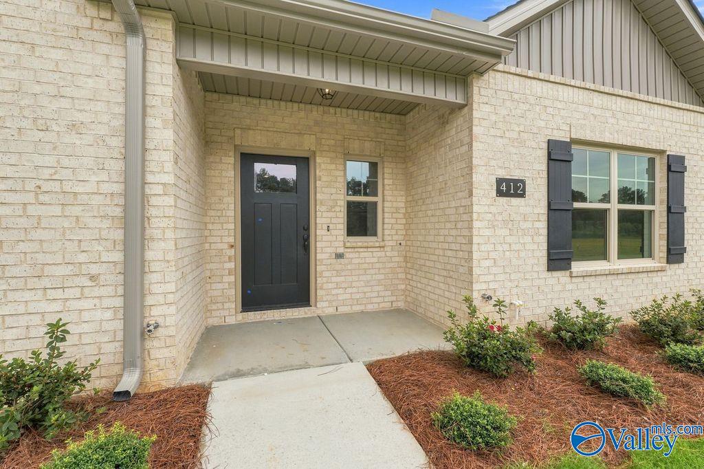 Brick exterior and covered front entryway of The Camilla B floor plan by Davidson Homes in The Retreat at Cain Park.