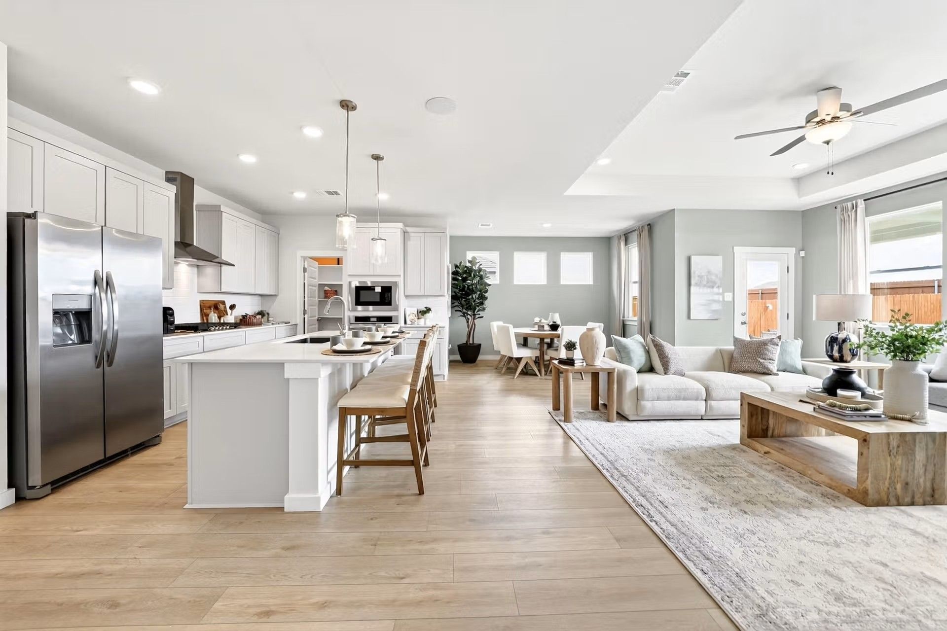 Open-concept kitchen and living area in The Laurel I floor plan by Davidson Homes in Heartland, Texas.