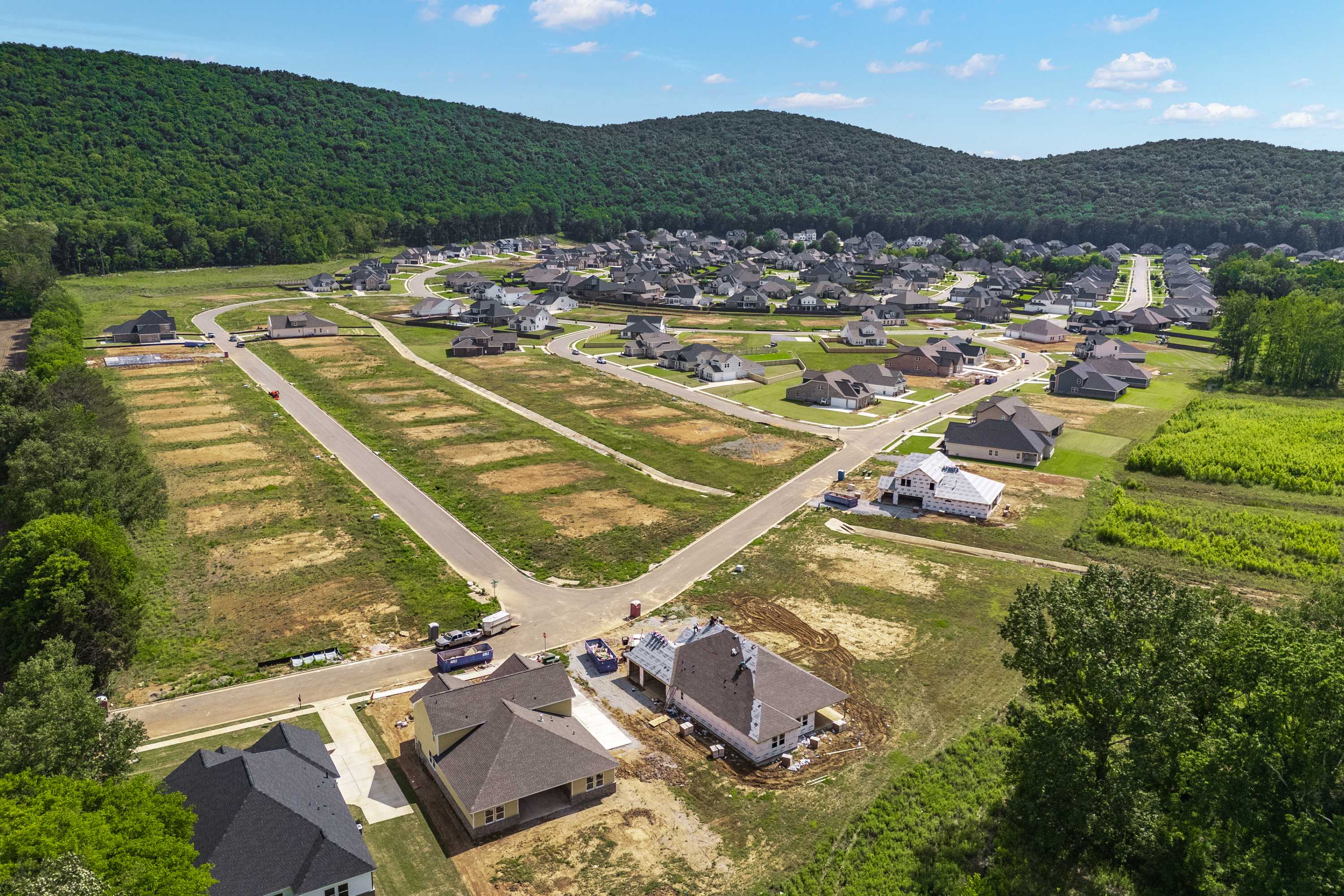 Aerial view of developing homes at The Meadows at Hampton Cove in Owens Cross Roads Alabama amid green hills