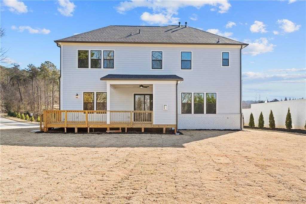 Two-story 5-bedroom Arlington A home exterior with covered front porch, balcony, and large windows in Tanglewood, East Cobb, Georgia