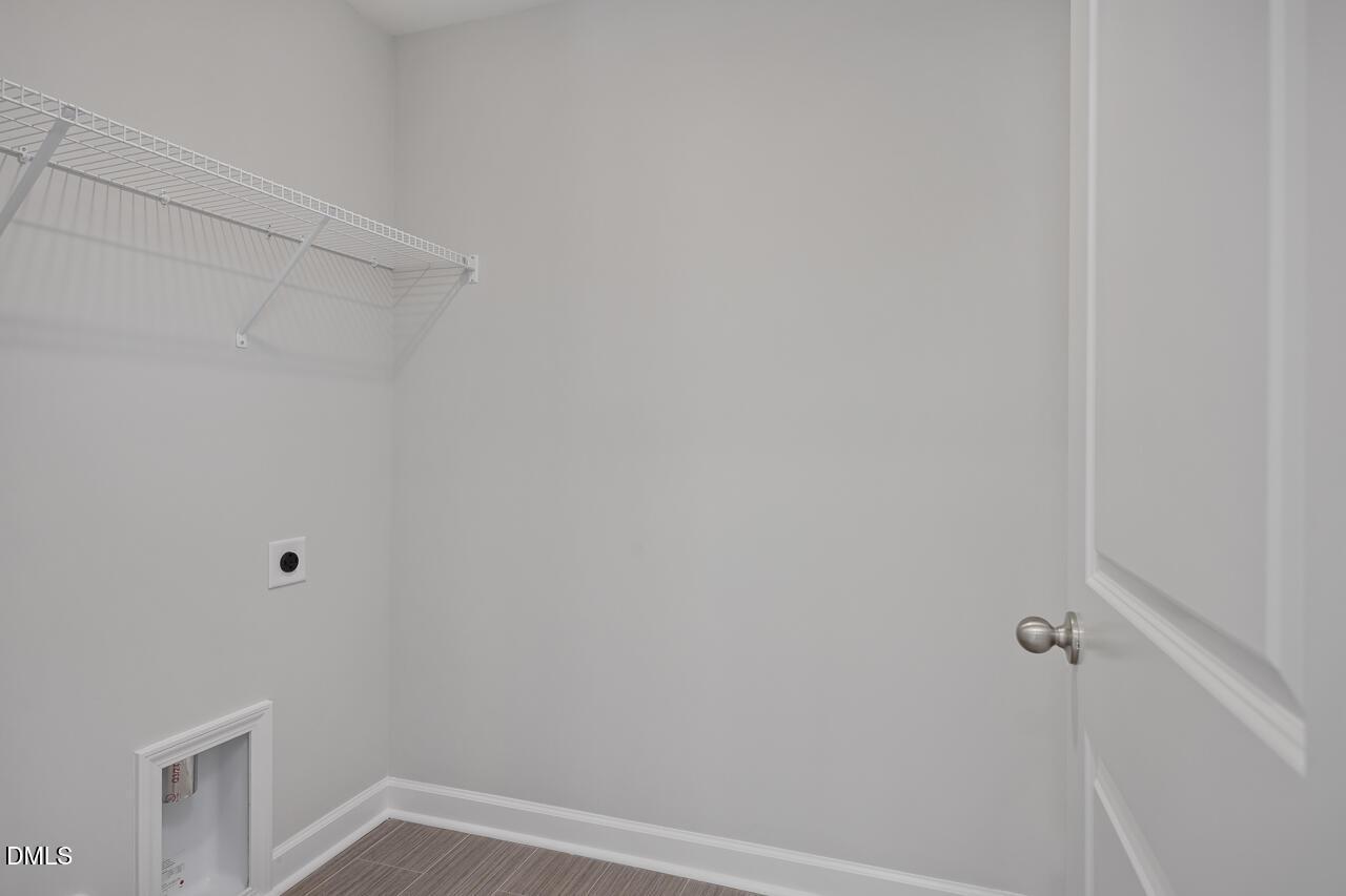 Laundry room with wire shelving in The Graham floor plan by Davidson Homes at Springvale in Fuquay-Varina, North Carolina.