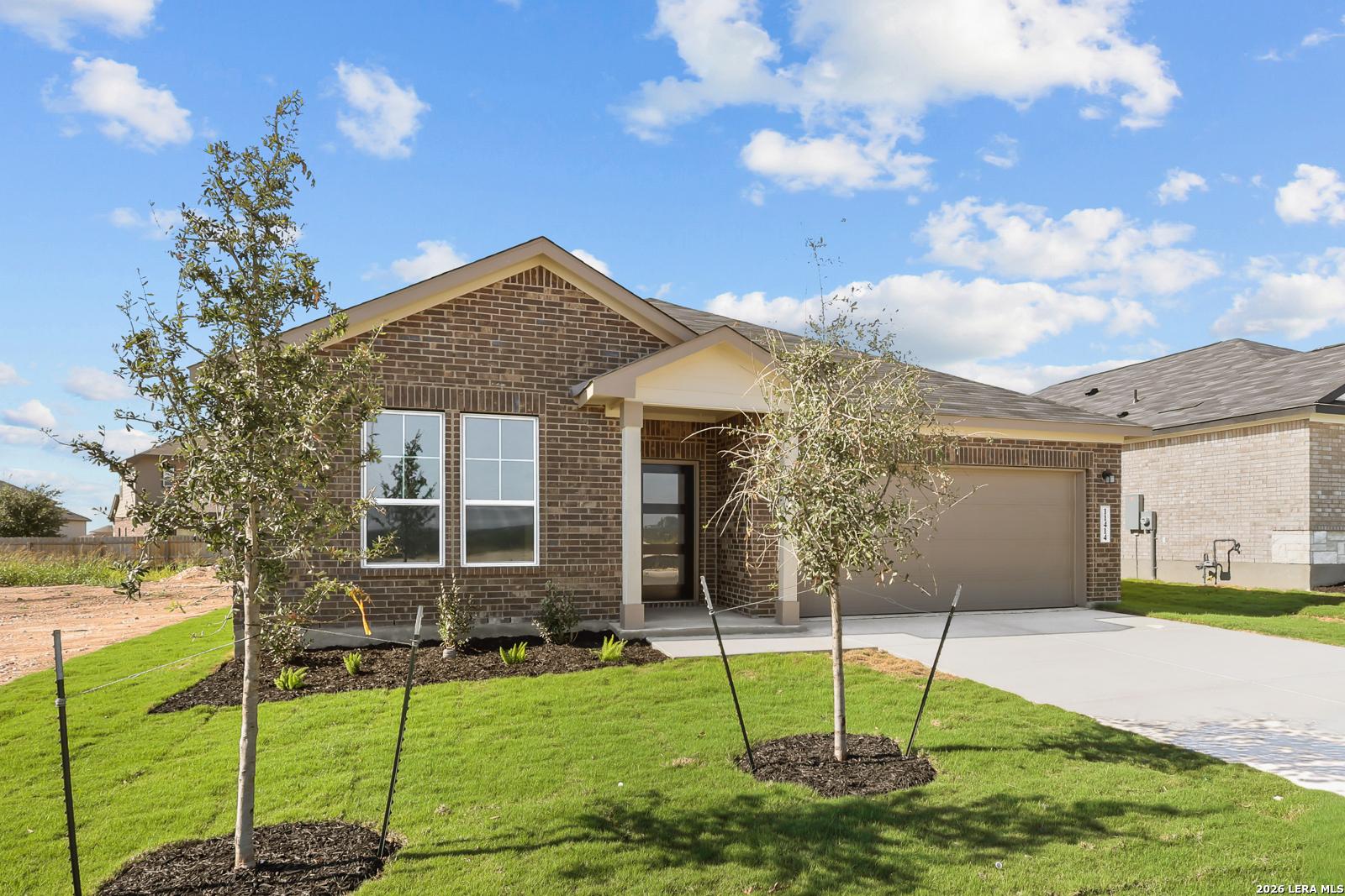Brick exterior of The Daphne I by Davidson Homes, 4-bed single-story home with 2-car garage in Bricewood, San Antonio, Texas