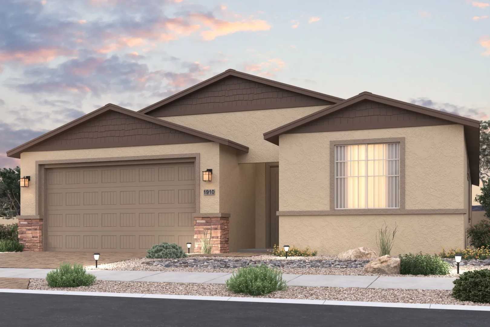 Contemporary single-story home exterior at North Ridge Pronghorn Ranch in Prescott Valley AZ featuring beige stucco, two-car garage, and desert landscaping