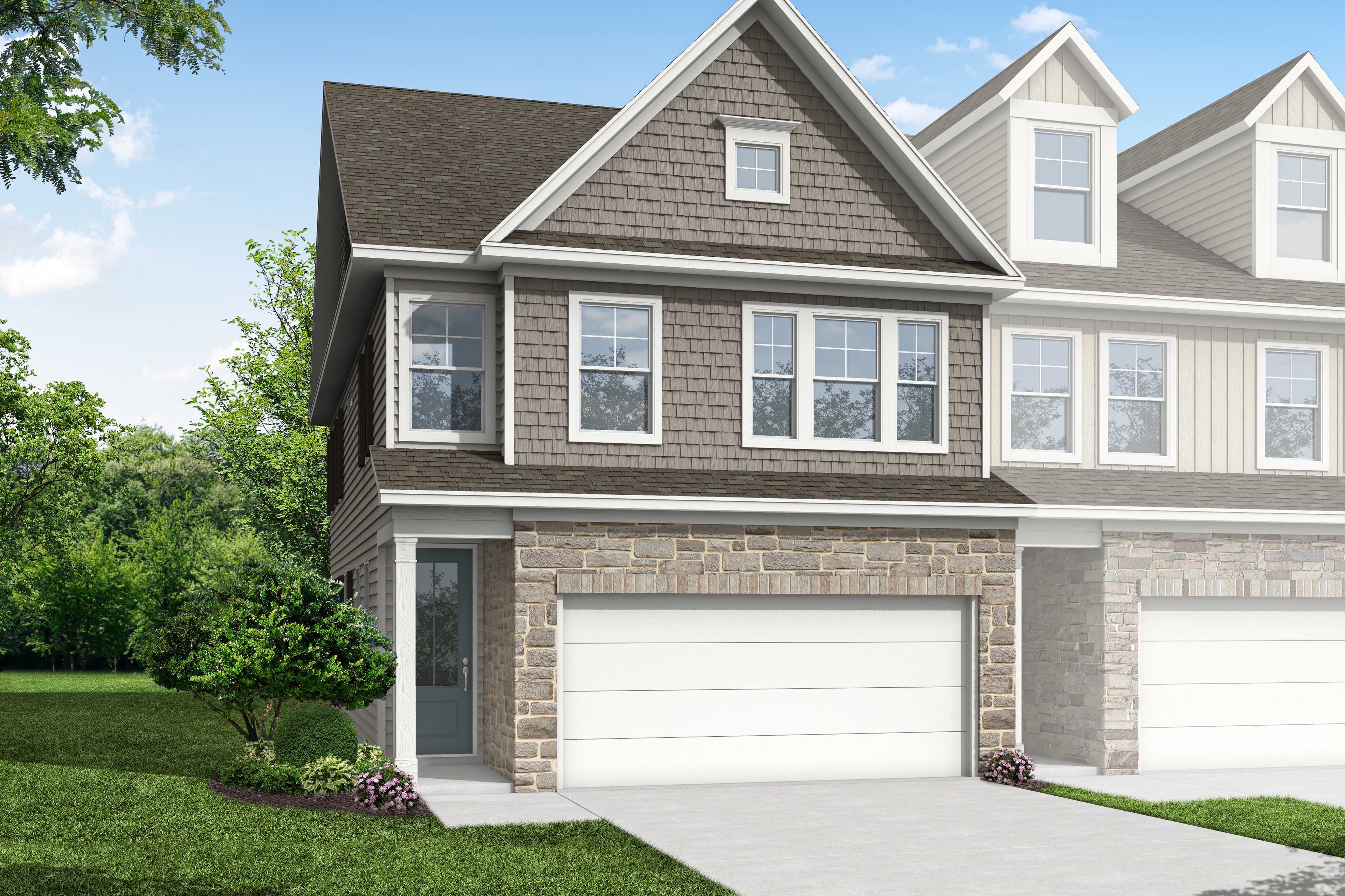 Modern two-story duplex exterior of The Durham F by Davidson Homes, stone accents, siding, dual garages, lush landscaping in Cumming, GA