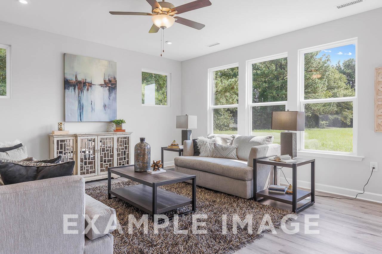 Davidson Homes the Chestnut Plan the living area with couches, side tables, coffee table, and decor