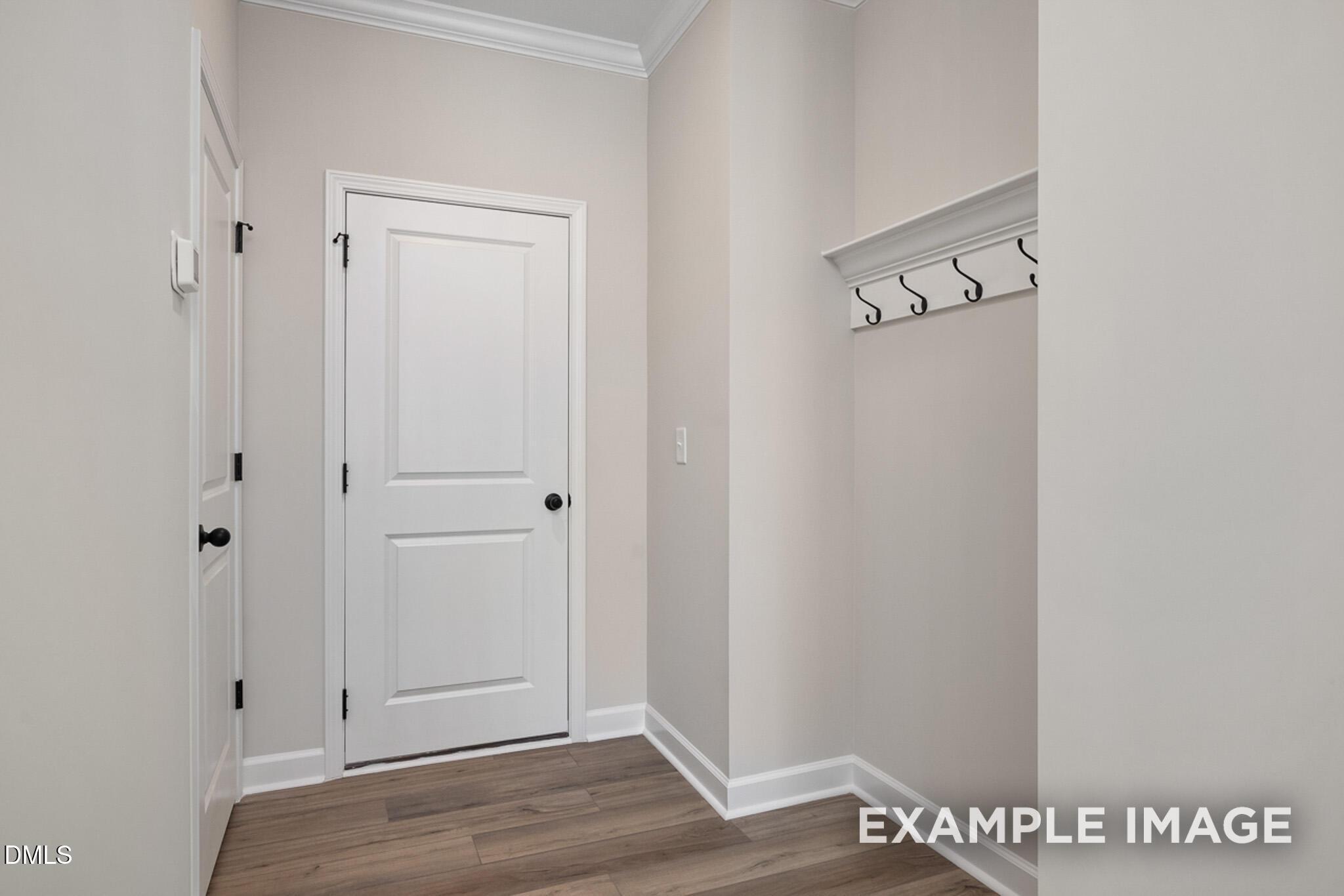 Mudroom area with wall-mounted coat hooks in The Mitchell floor plan at Camden Park, Knightdale, North Carolina.