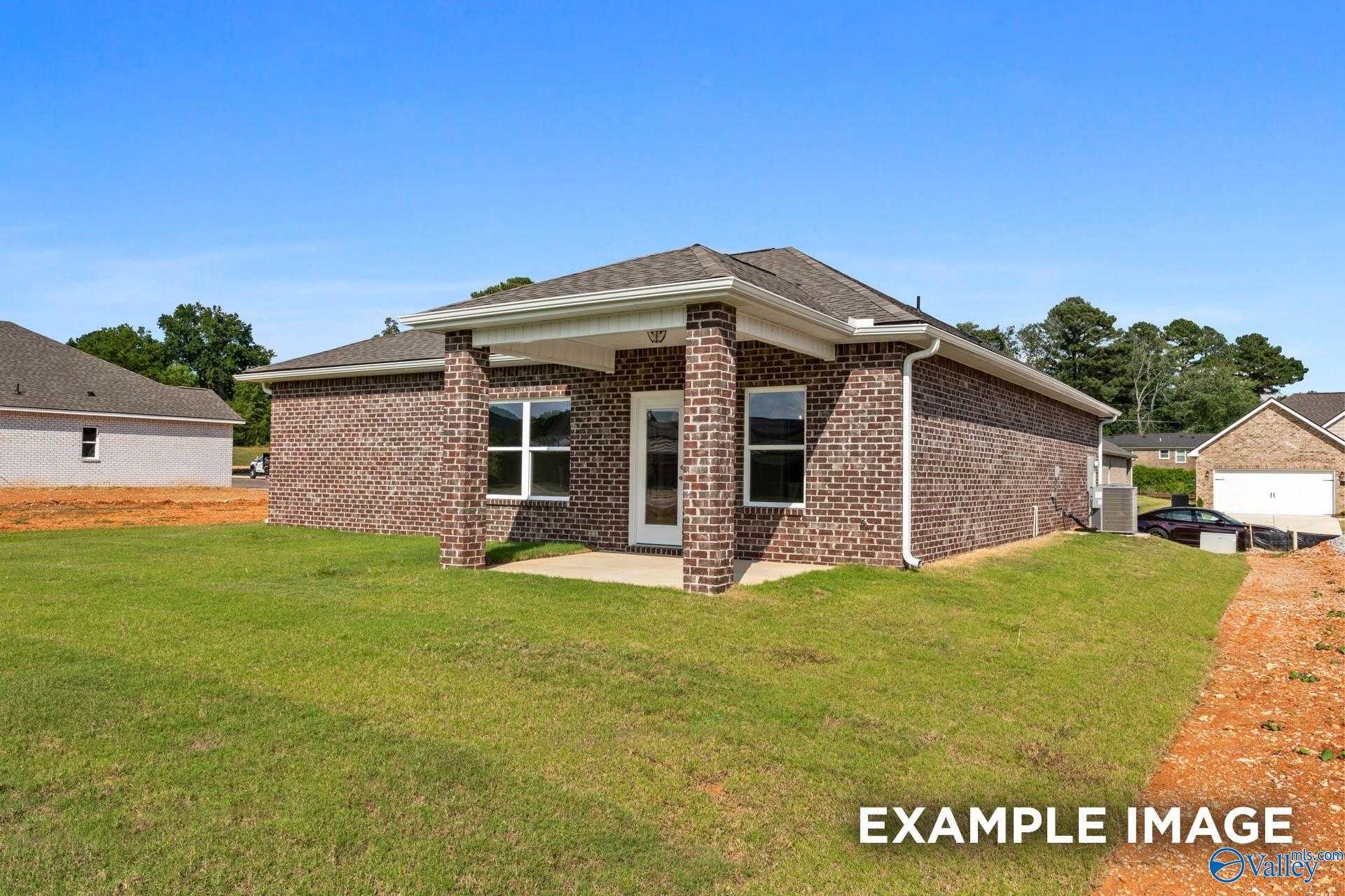 Brick one-story home with covered porch, large windows, and 2-car garage in Jaguar Hills, Huntsville, AL by Davidson Homes The Butler