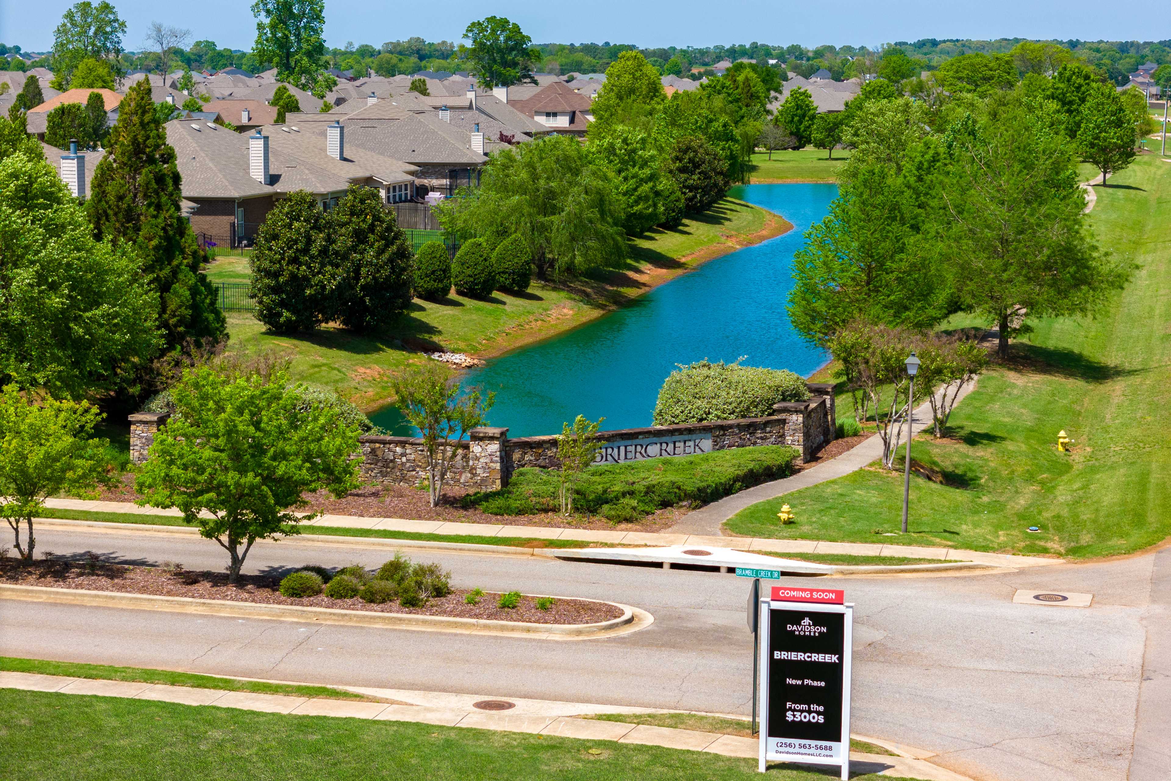 Aerial view of Briercreek neighborhood in Meridianville Alabama featuring homes trees scenic pond and Davidson Homes entrance sign