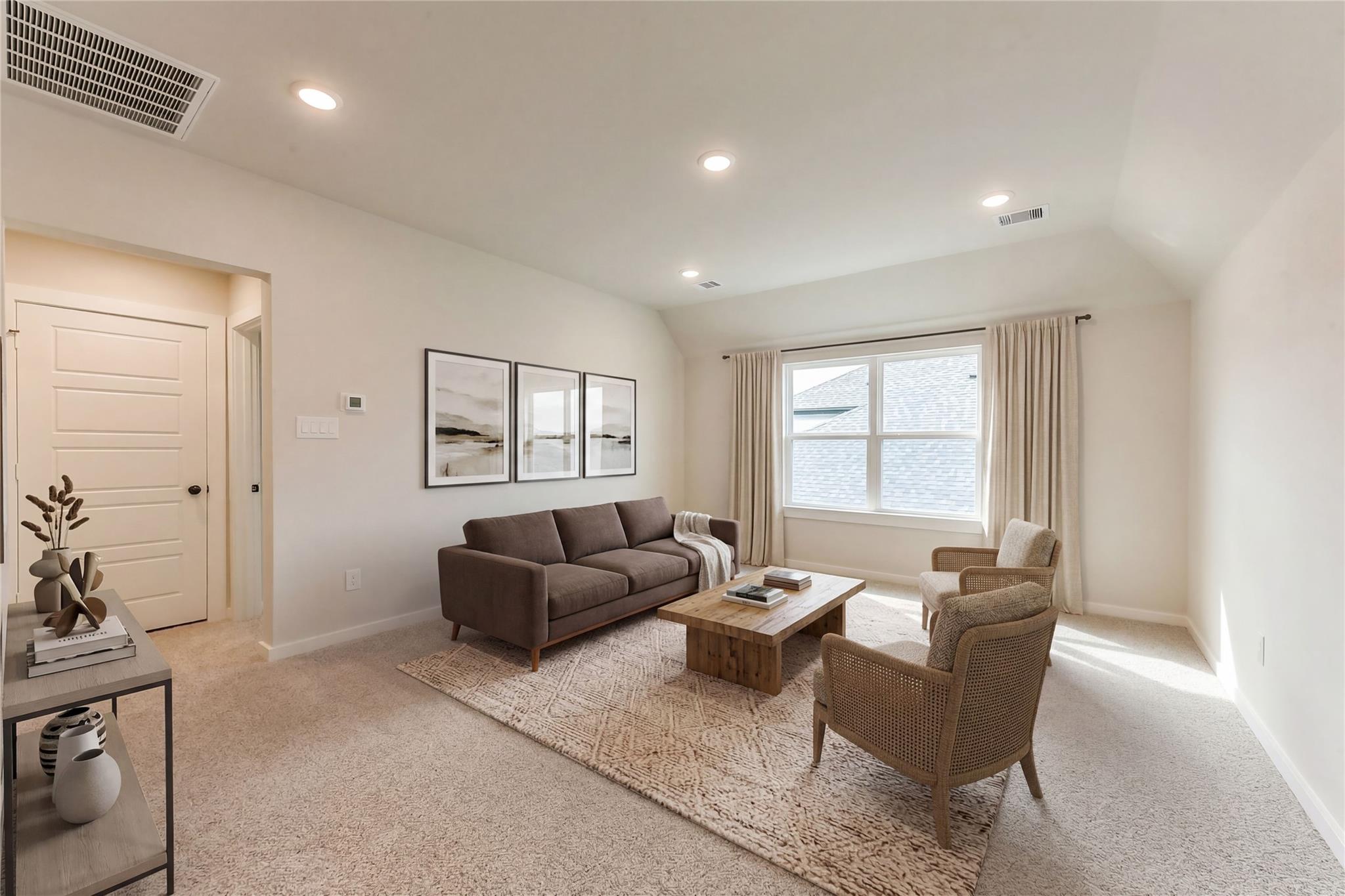 Cozy living room with brown sofa, rattan armchair, large windows, and abstract art in Davidson Homes Sequoia C, Sundance Cove, Crosby Texas