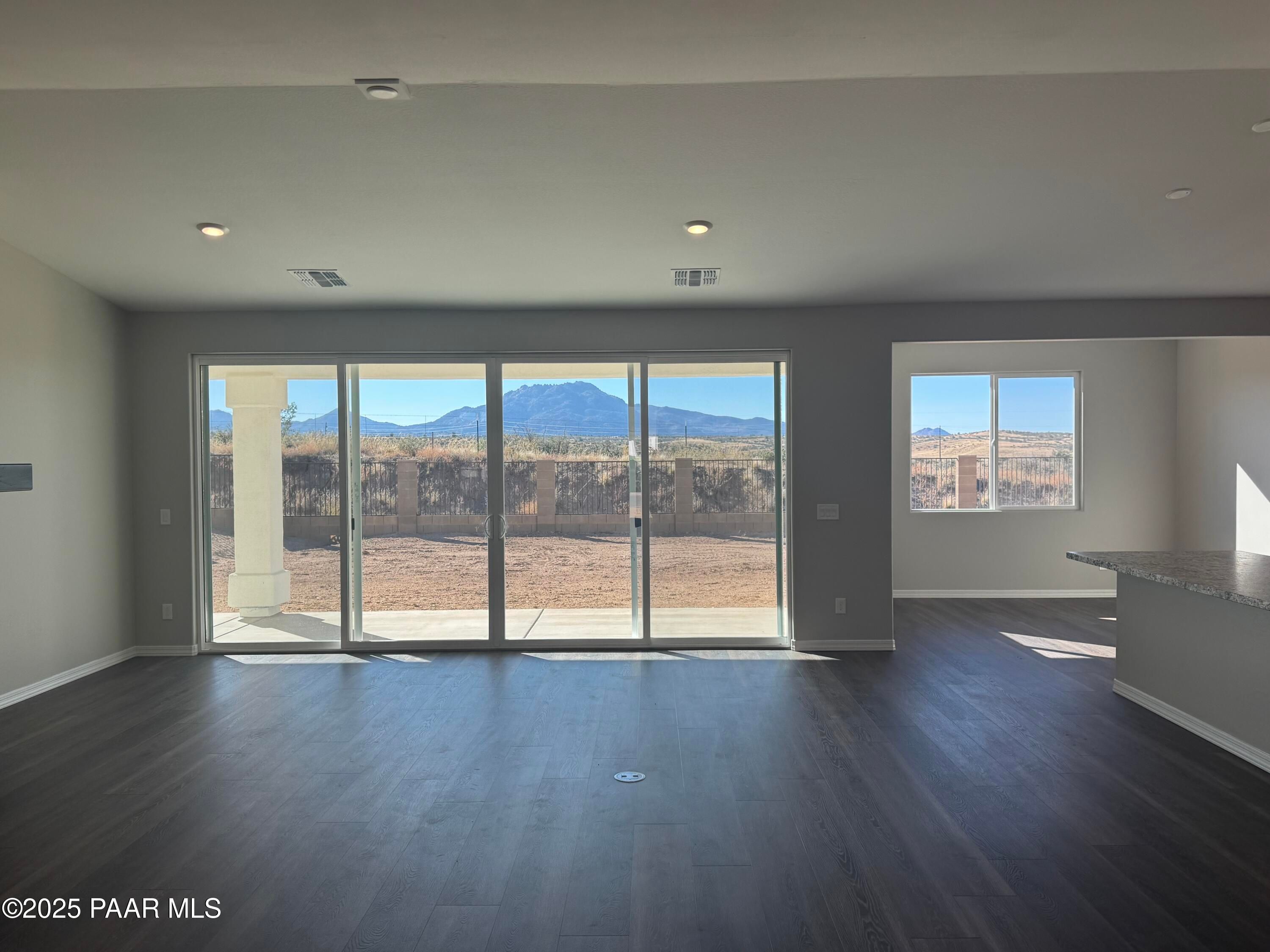 Open great room with large sliding doors to mountain-view backyard in Davidson Homes The Monarch E, Prescott, Arizona