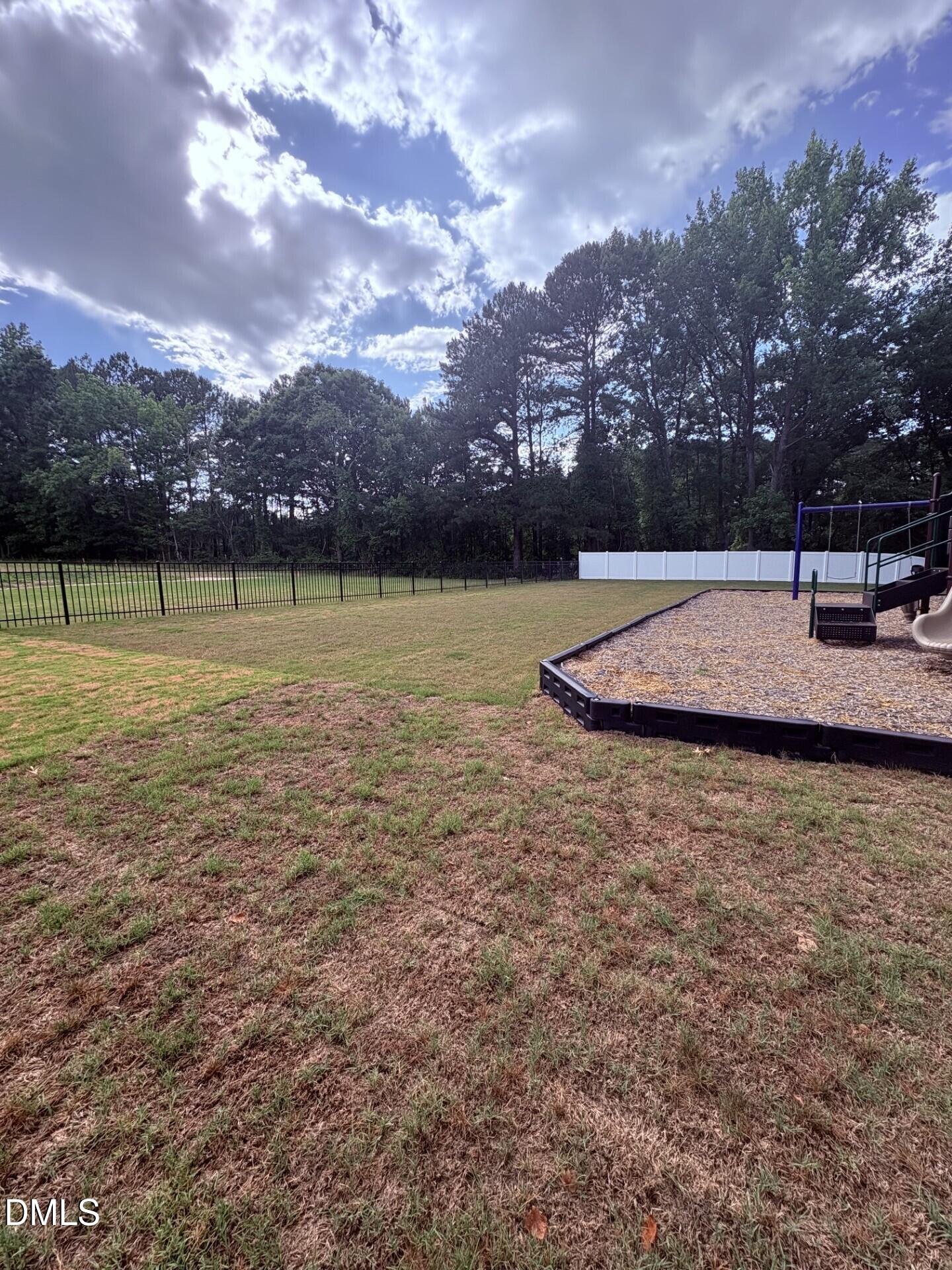 Spacious fenced backyard with private playground in Woodland Crossing, Zebulon, North Carolina.
