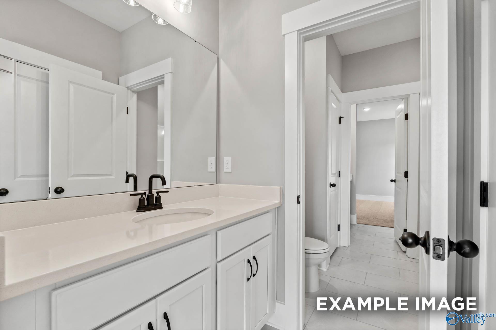 Modern bathroom vanity with white cabinets and quartz countertop in The Finleigh floor plan at Briercreek, Meridianville.