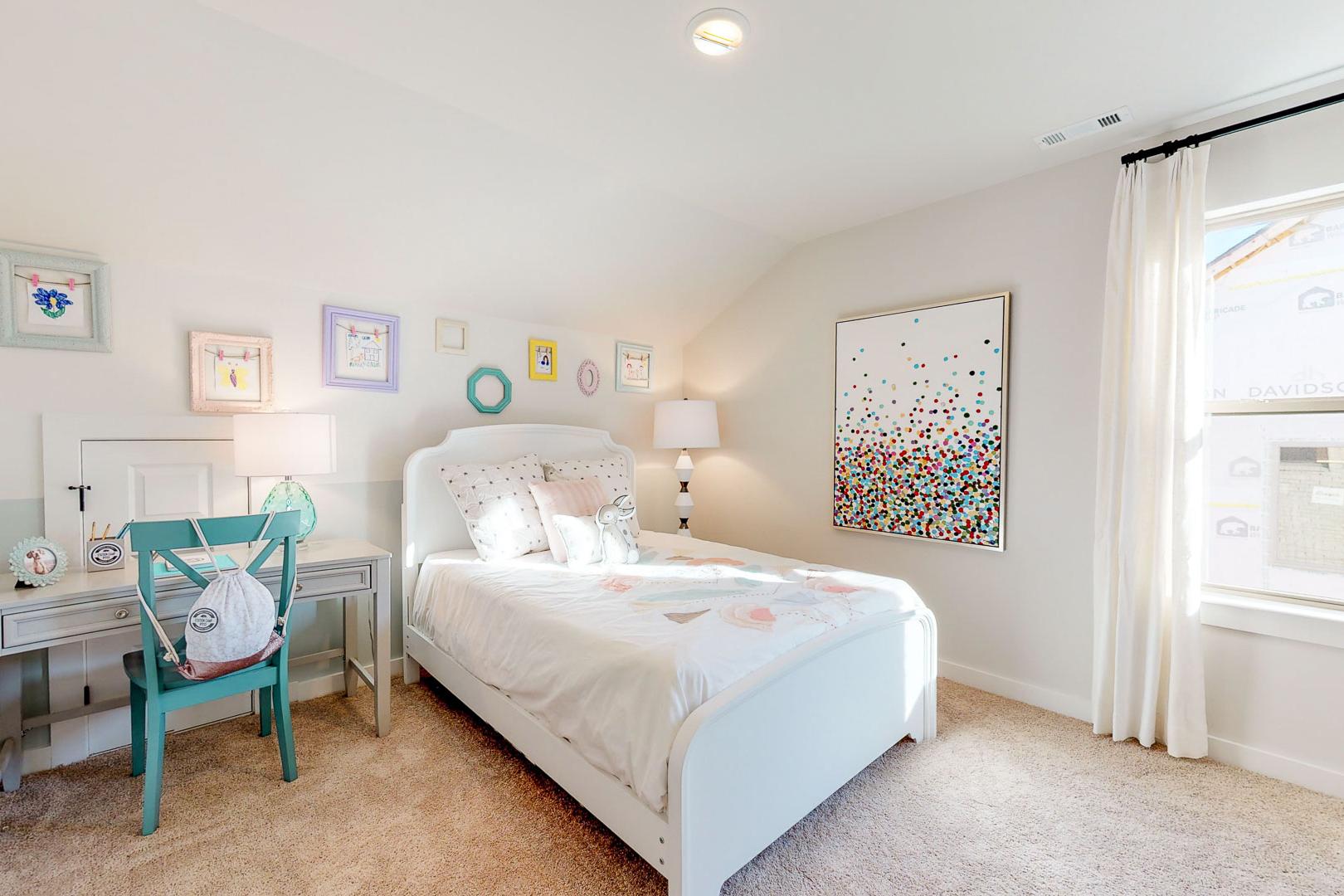 Charming girl's bedroom with twin bed, turquoise desk, colorful wall art in Liberty Creek, Gallatin, Tennessee