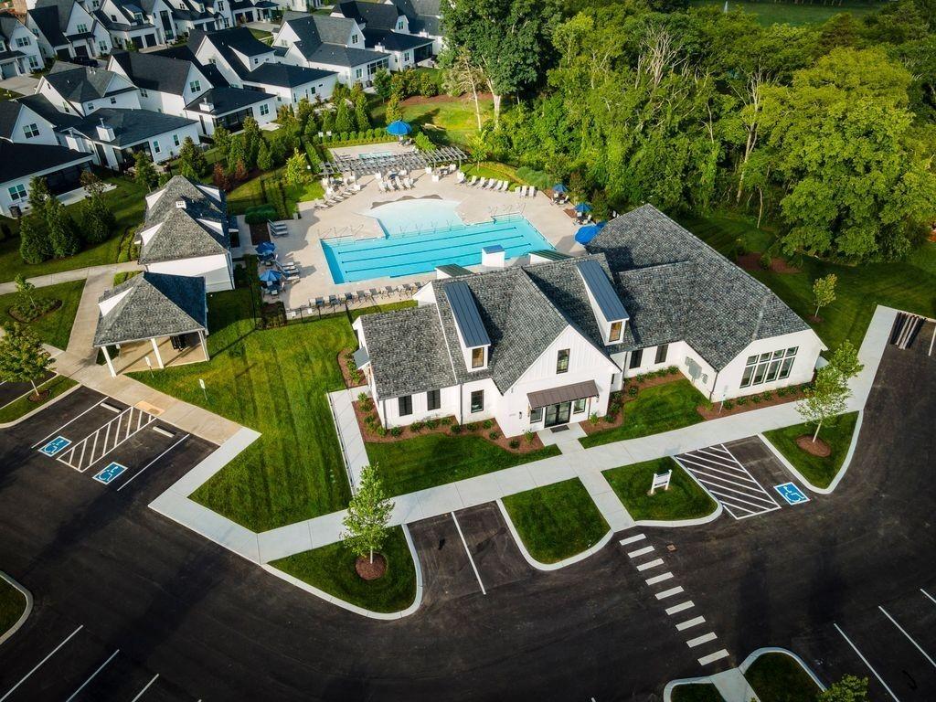 Aerial view of resort-style community pool, lounge area, and modern clubhouse amid homes in Shelton Square, Murfreesboro, Tennessee