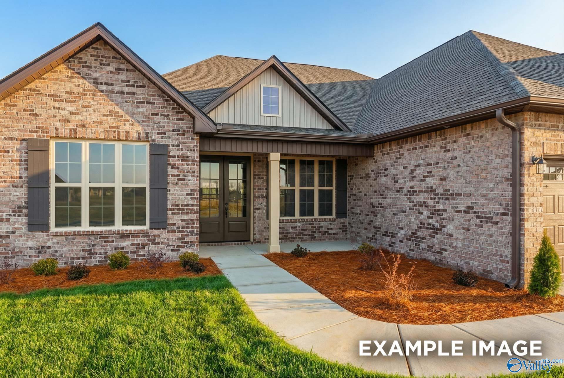 Modern brick 1.5-story Finleigh home with gabled roof, shuttered windows, columned porch, and landscaped front yard in Hollon Meadow, Decatur, Alabama