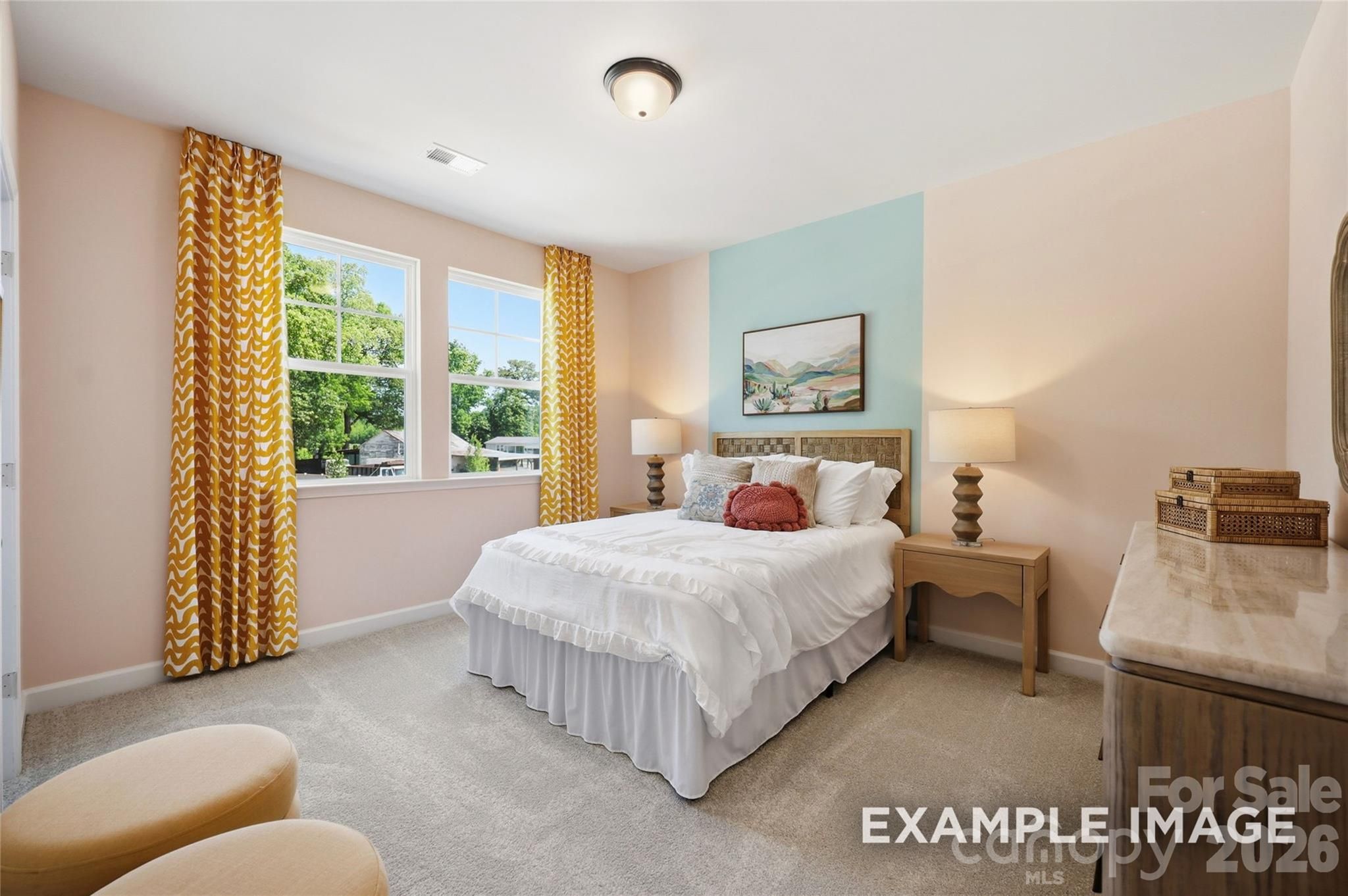 Bright bedroom with white bedding and peach walls in Davidson Homes' Aspen B floor plan, Windgate, Mooresville, NC