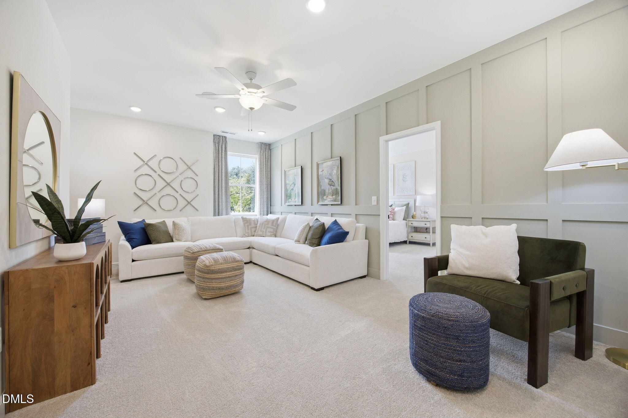 Modern living room with sectional sofa and board-and-batten wall in The Ashport M floor plan at Wendell Ridge, North Carolina