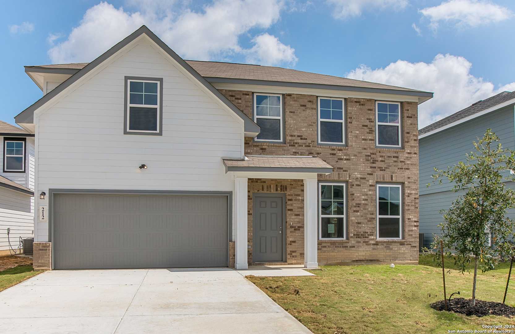 Modern two-story 4-bedroom home exterior with brick accents, 2-car garage in Hannah Heights, Seguin, Texas by Davidson Homes The Murray H