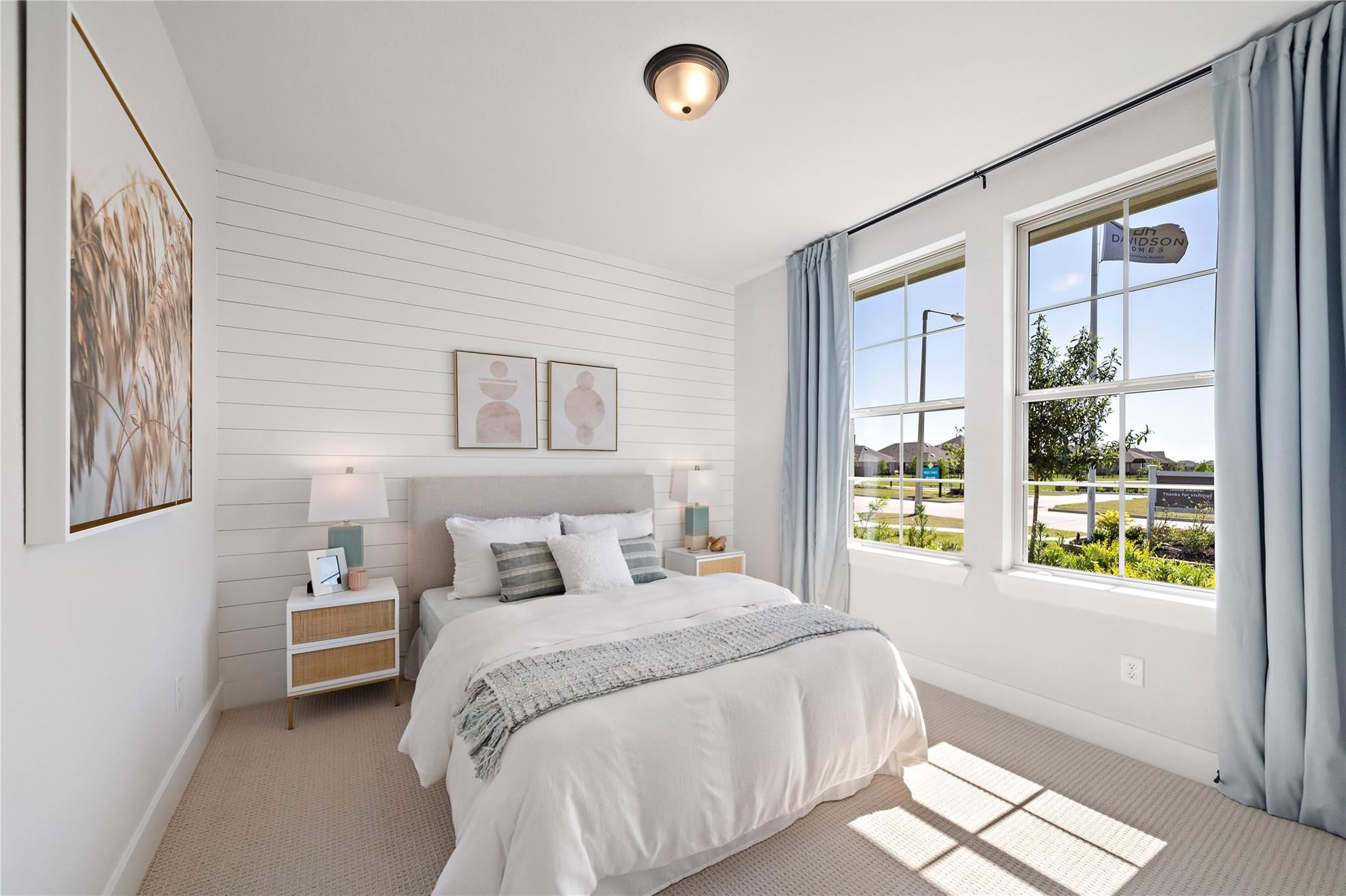 Bright bedroom with shiplap accent wall and large windows in Davidson Homes The Edward A, Lago Mar, Texas City