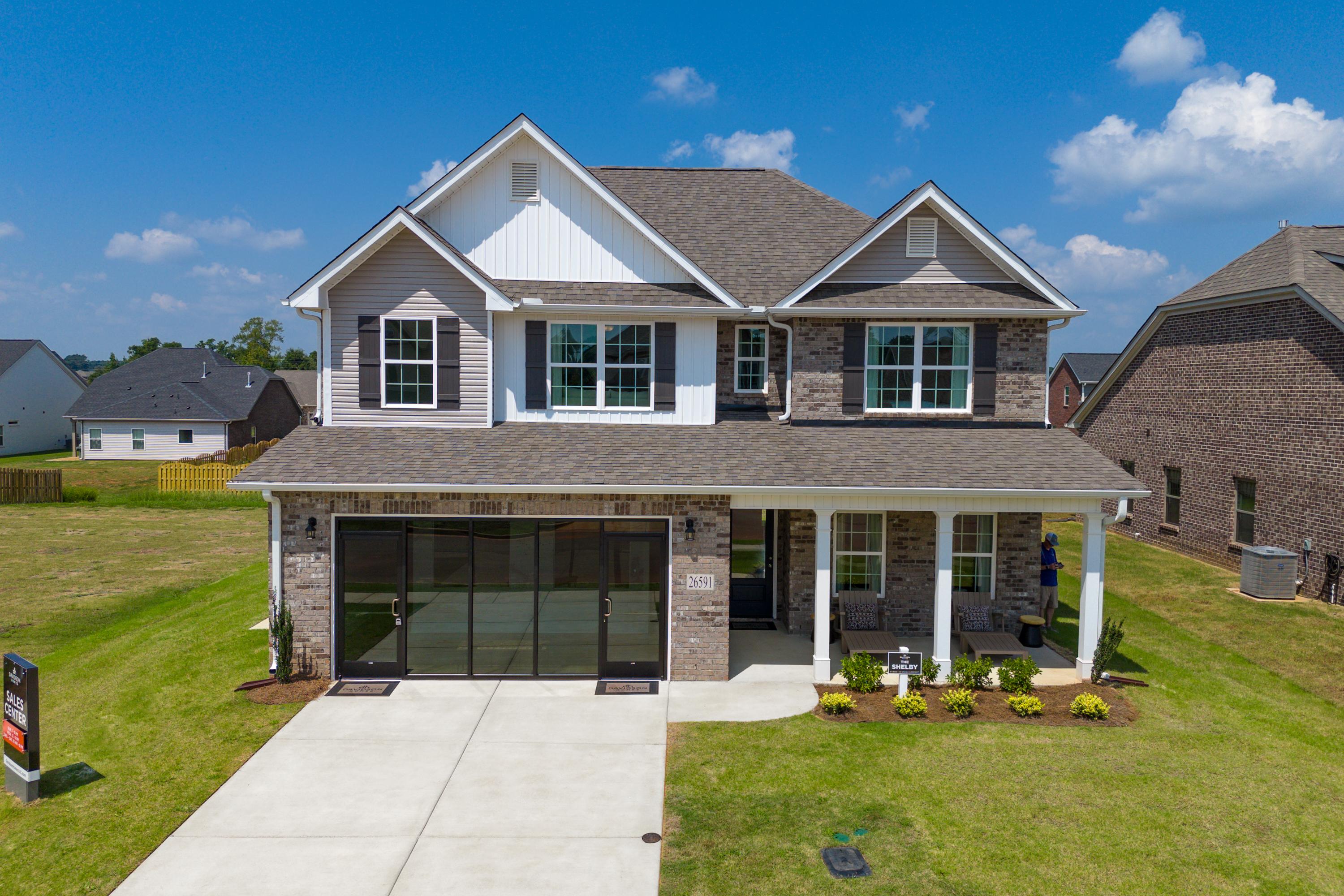 Modern two-story home exterior at Ricketts Farm in Athens, Alabama with brick accents, covered porch, and attached garage