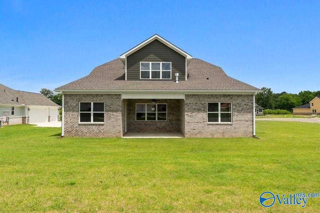 Brick 1.5-story The Oxford home exterior with covered front porch, large windows, and manicured lawn in The Meadows at Hampton Cove, Owens Cross Roads, Alabama