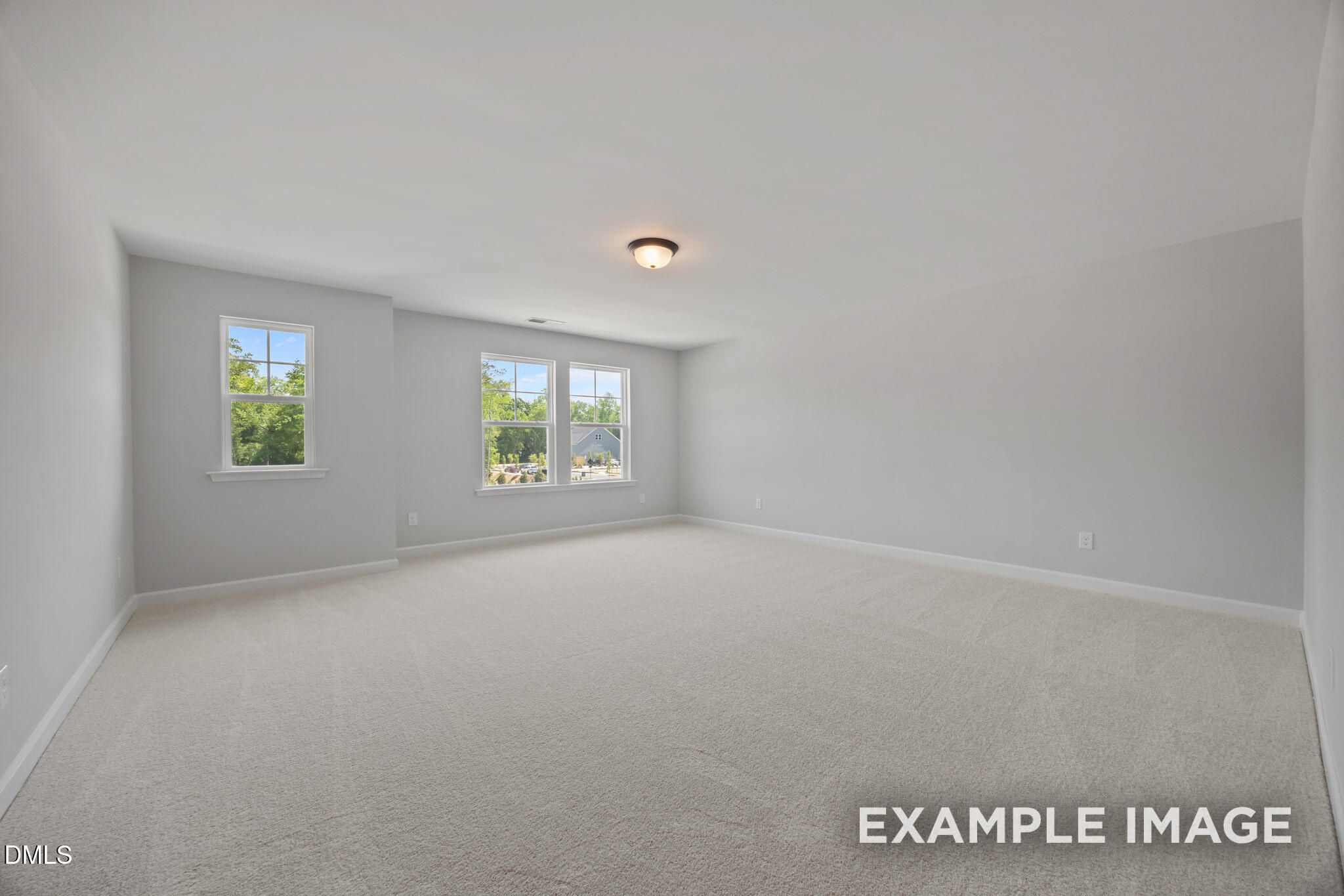 Bright spacious bedroom with plush carpet and double windows in Davidson Homes The Beech floor plan, Wendell Ridge, NC