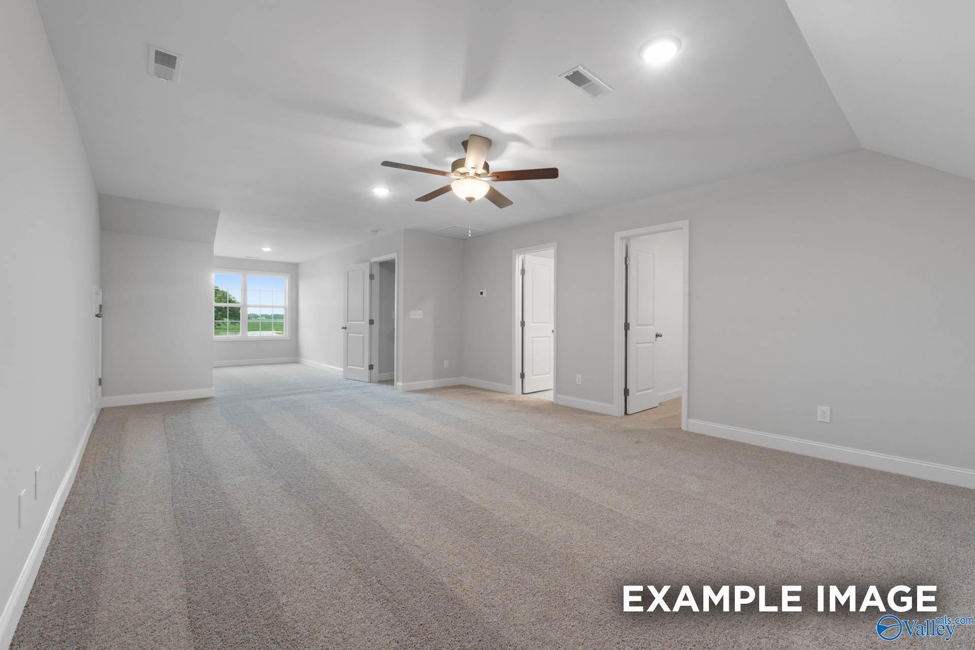 Spacious carpeted bonus room in The Rockford floor plan by Davidson Homes at Pikes Ridge in Meridianville, Alabama.