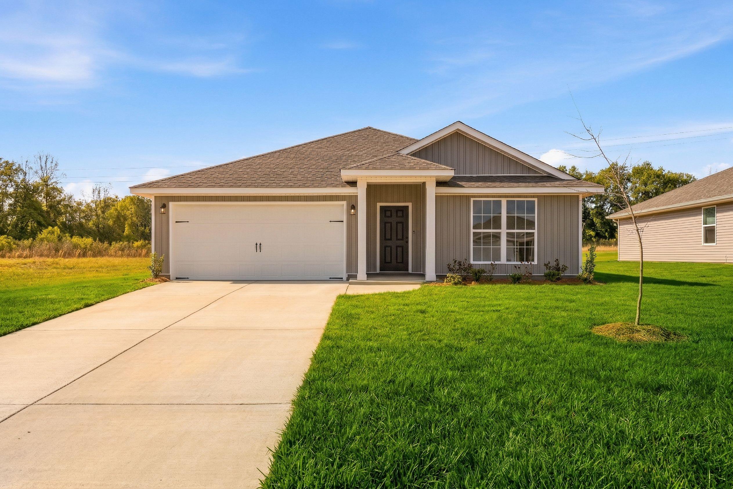 Gray craftsman ranch home exterior in Chapel Hill Athens Alabama with attached garage, covered porch, and green lawn