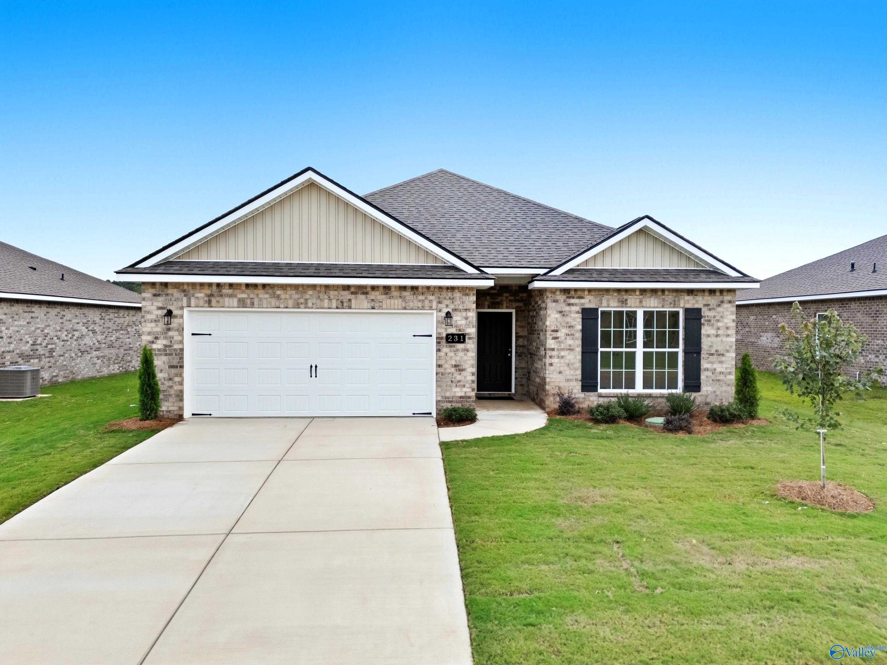 Modern 1-story brick home with 2-car garage, driveway, and lush lawn in Lynn Meadows, Meridianville, Alabama - The Everett by Davidson Homes