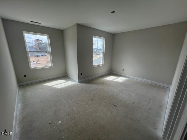 Bright empty secondary bedroom with large windows and natural light in Davidson Homes The Preston A, Lillington, NC
