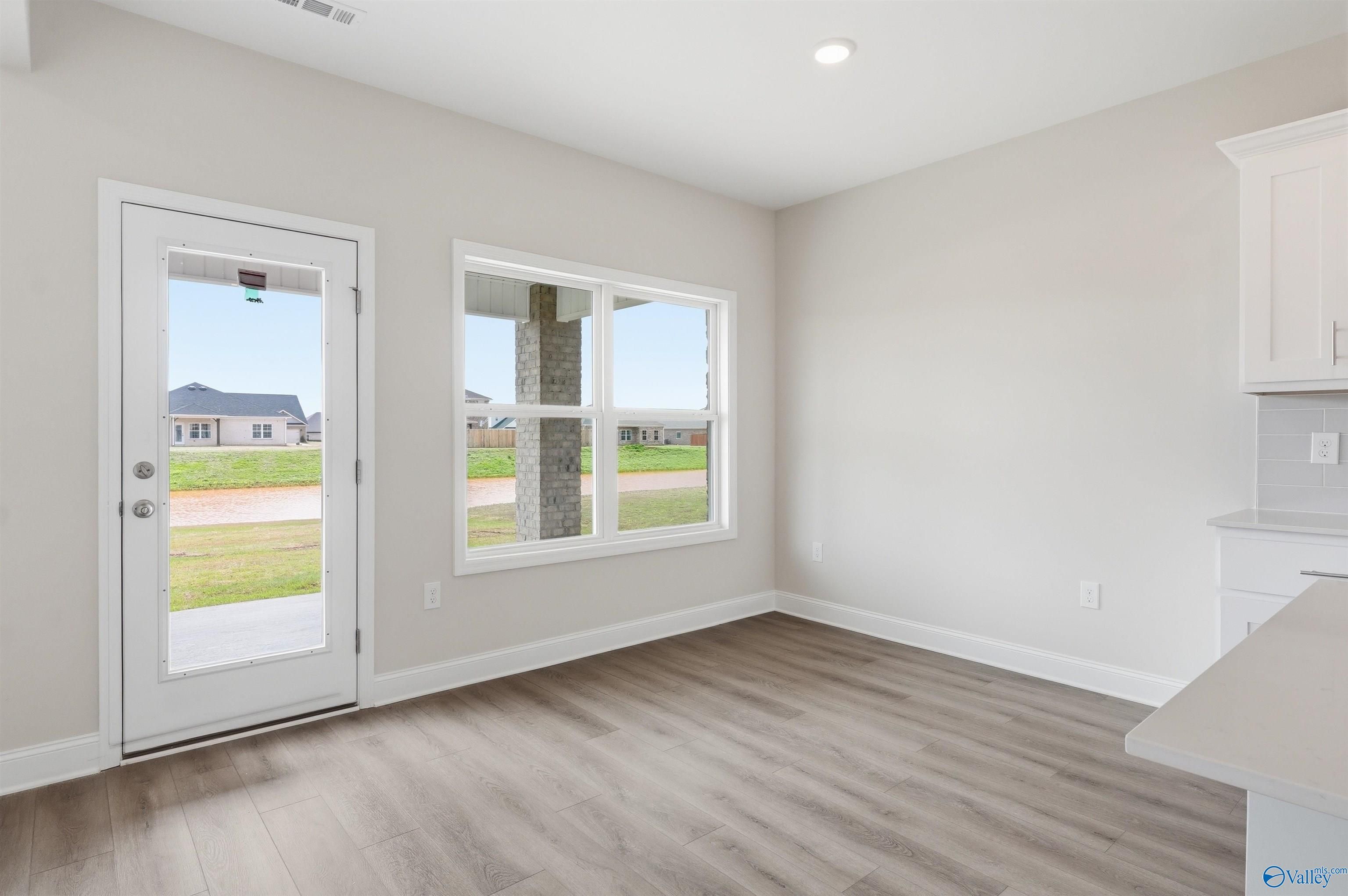 Bright breakfast nook with backyard views in The Shelby D floor plan at Evergreen Mill, Madison, Alabama.