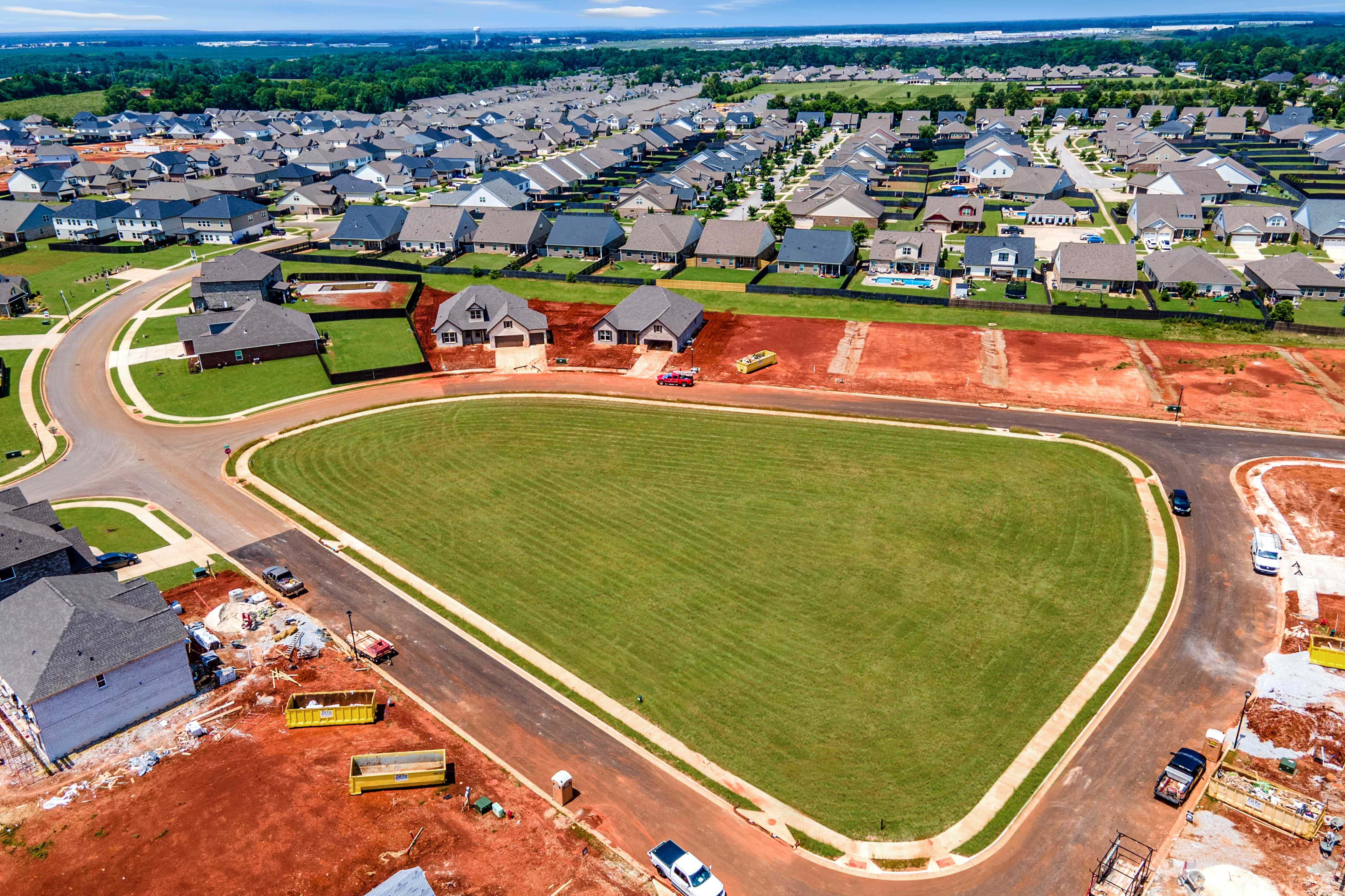 Aerial view of Barnett's Crossing in Madison Alabama with new homes, green lots, and active construction by Davidson Homes