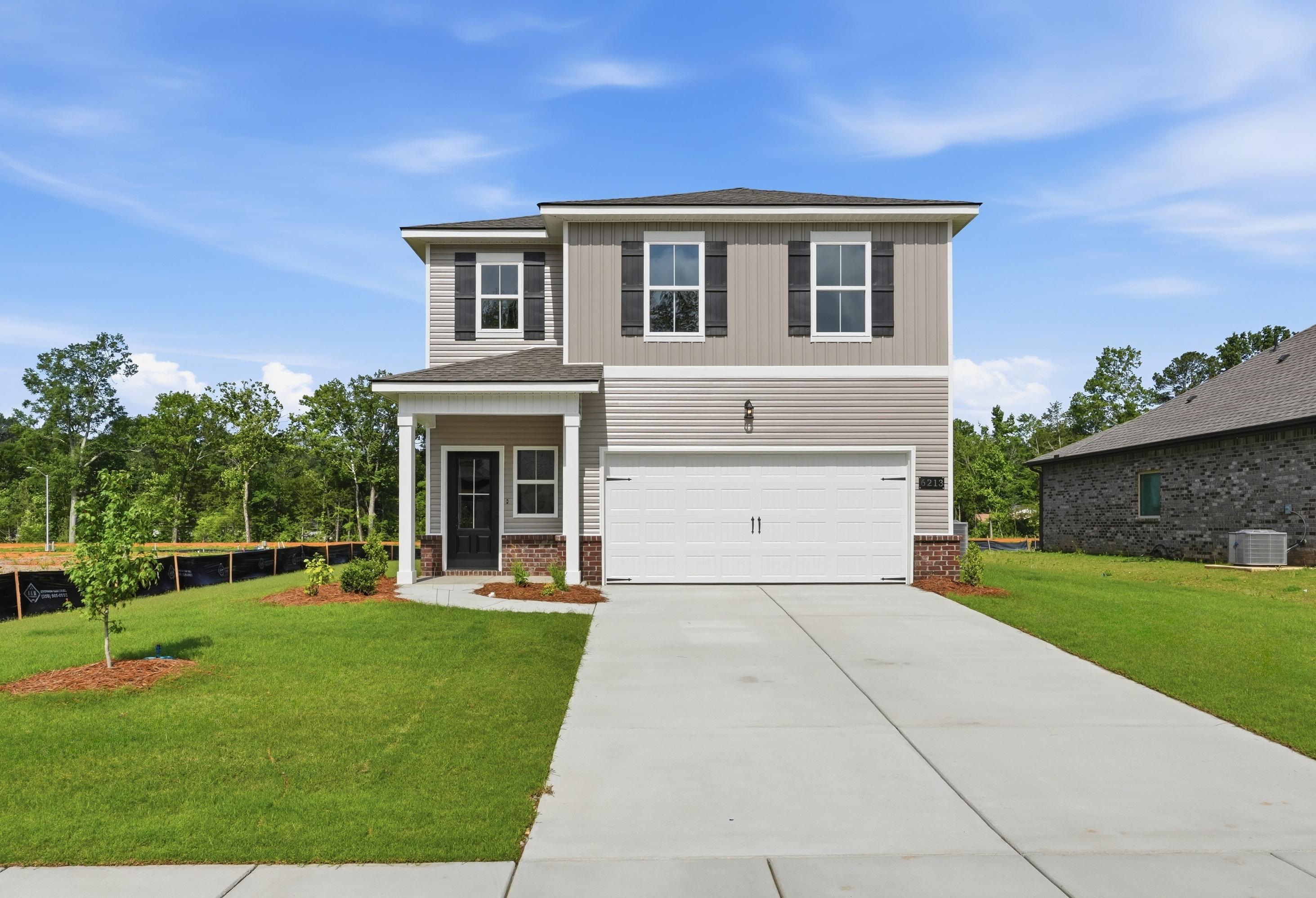 The Russell A two-story single-family home in New Market featuring a two-car garage, brick accents, and modern siding.