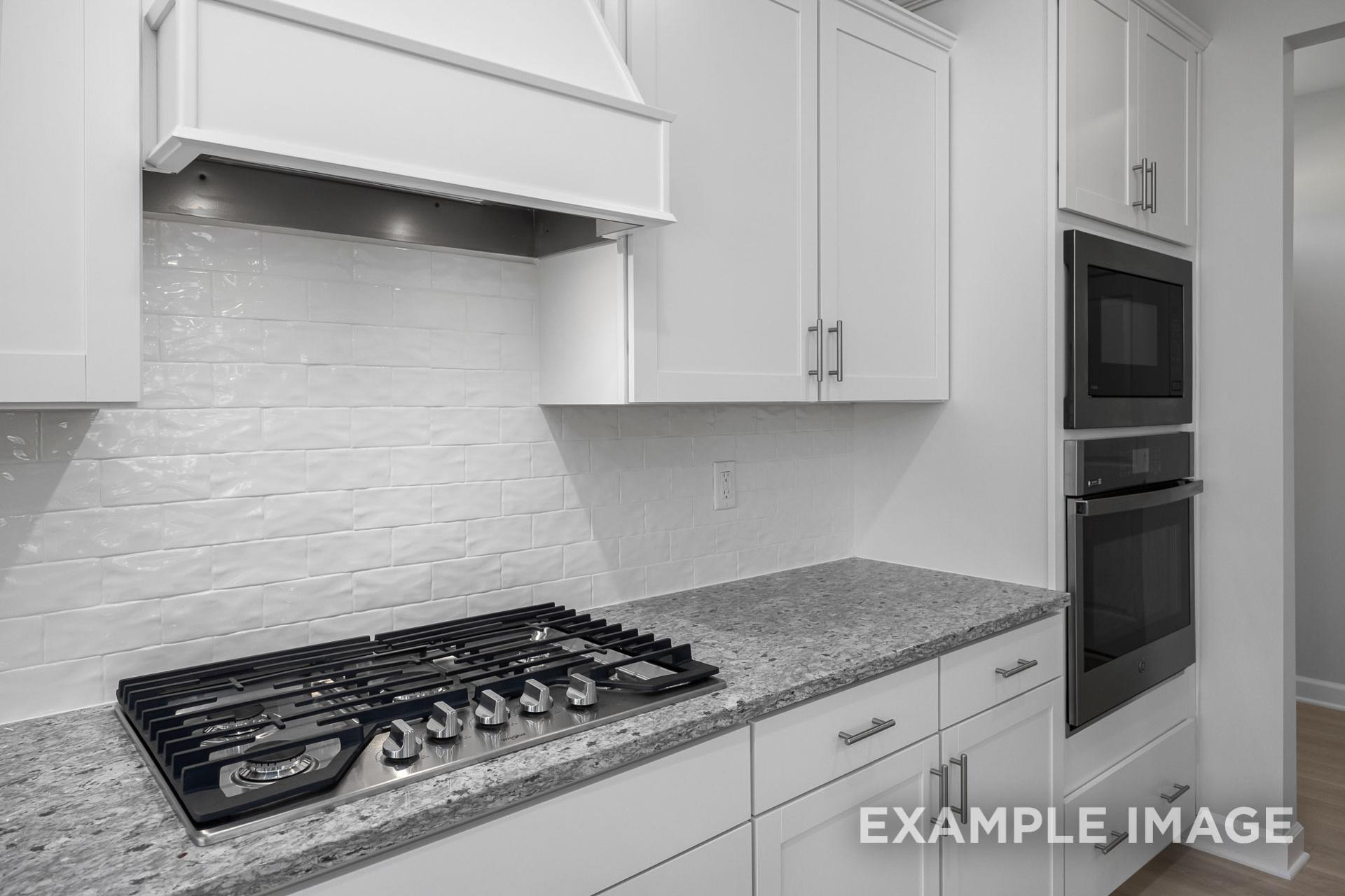 Modern Gavin B kitchen with white shaker cabinets, subway tile backsplash, gas cooktop, and double wall oven